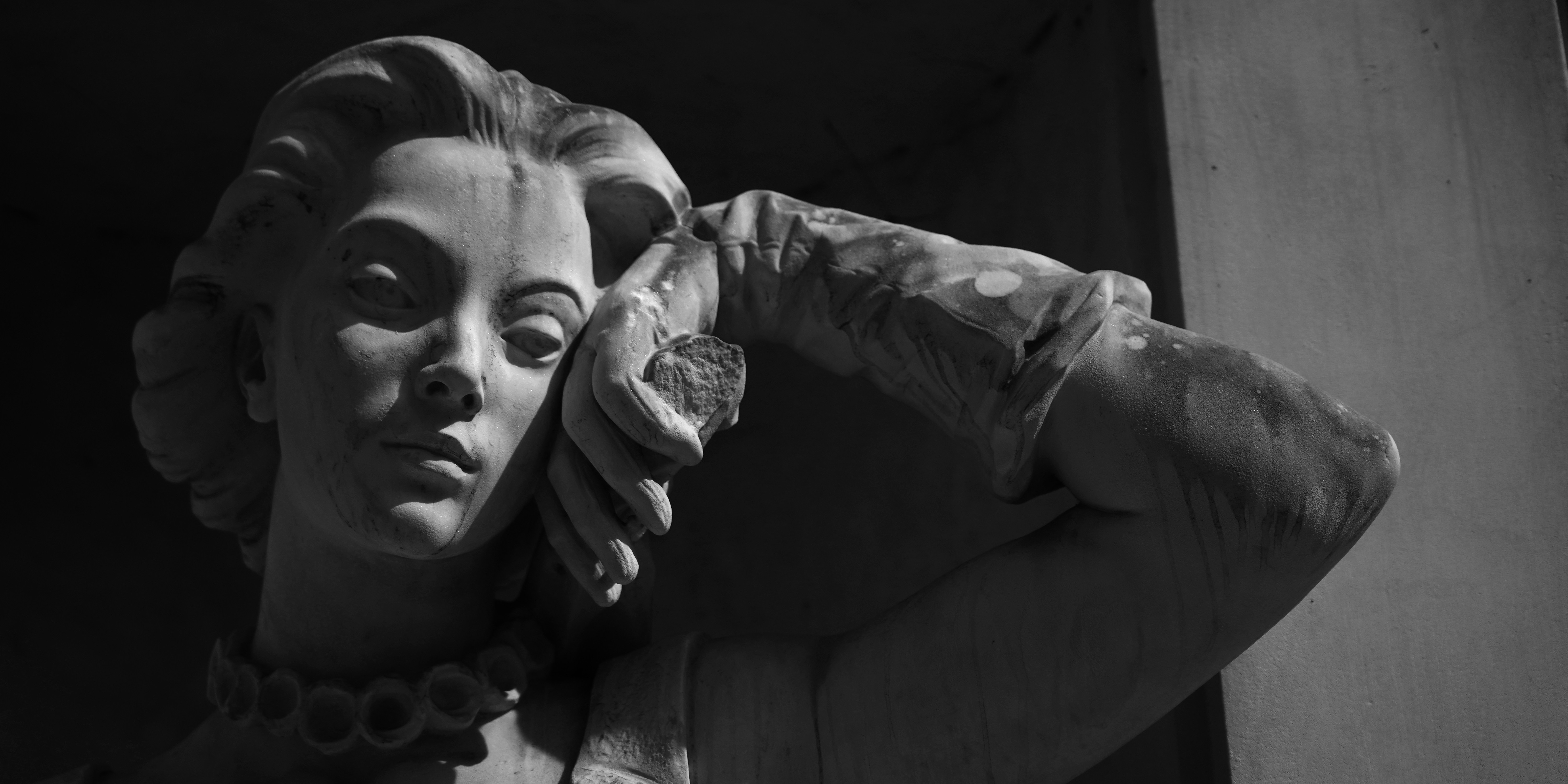 Black and white sculpture of a woman's face.