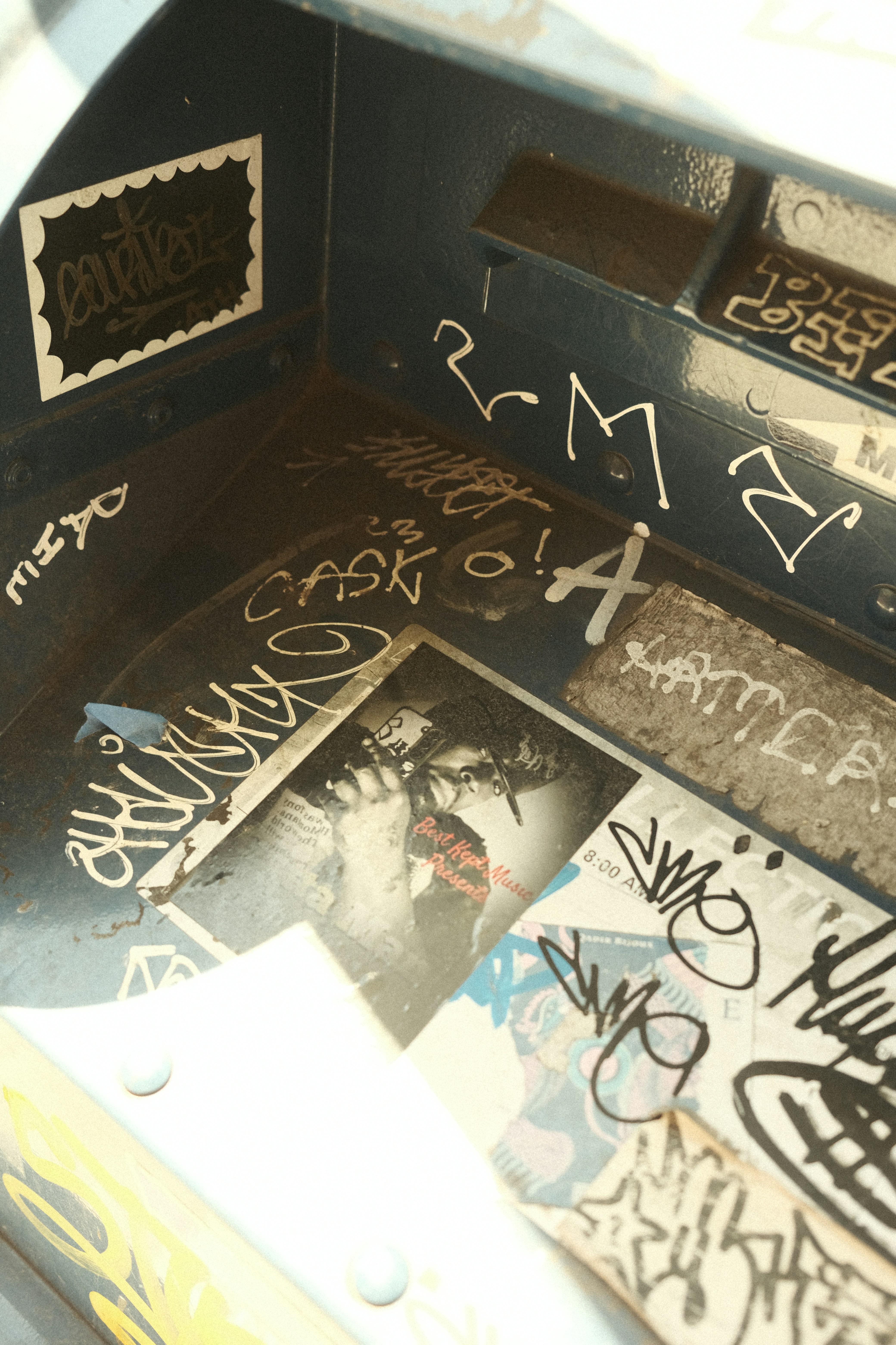 Graffiti-covered interior of a blue metal box