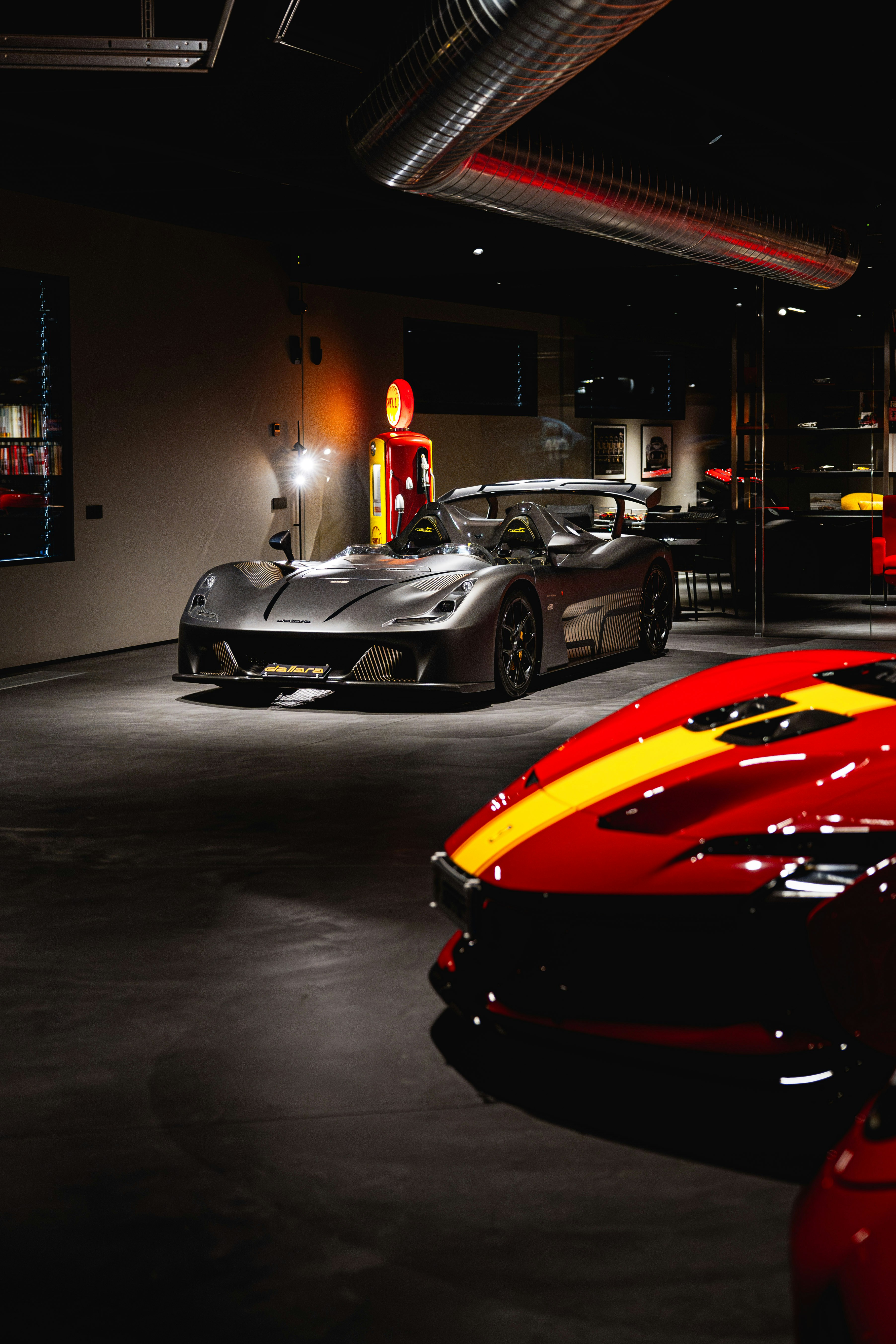 Sleek sports cars displayed in a modern showroom.