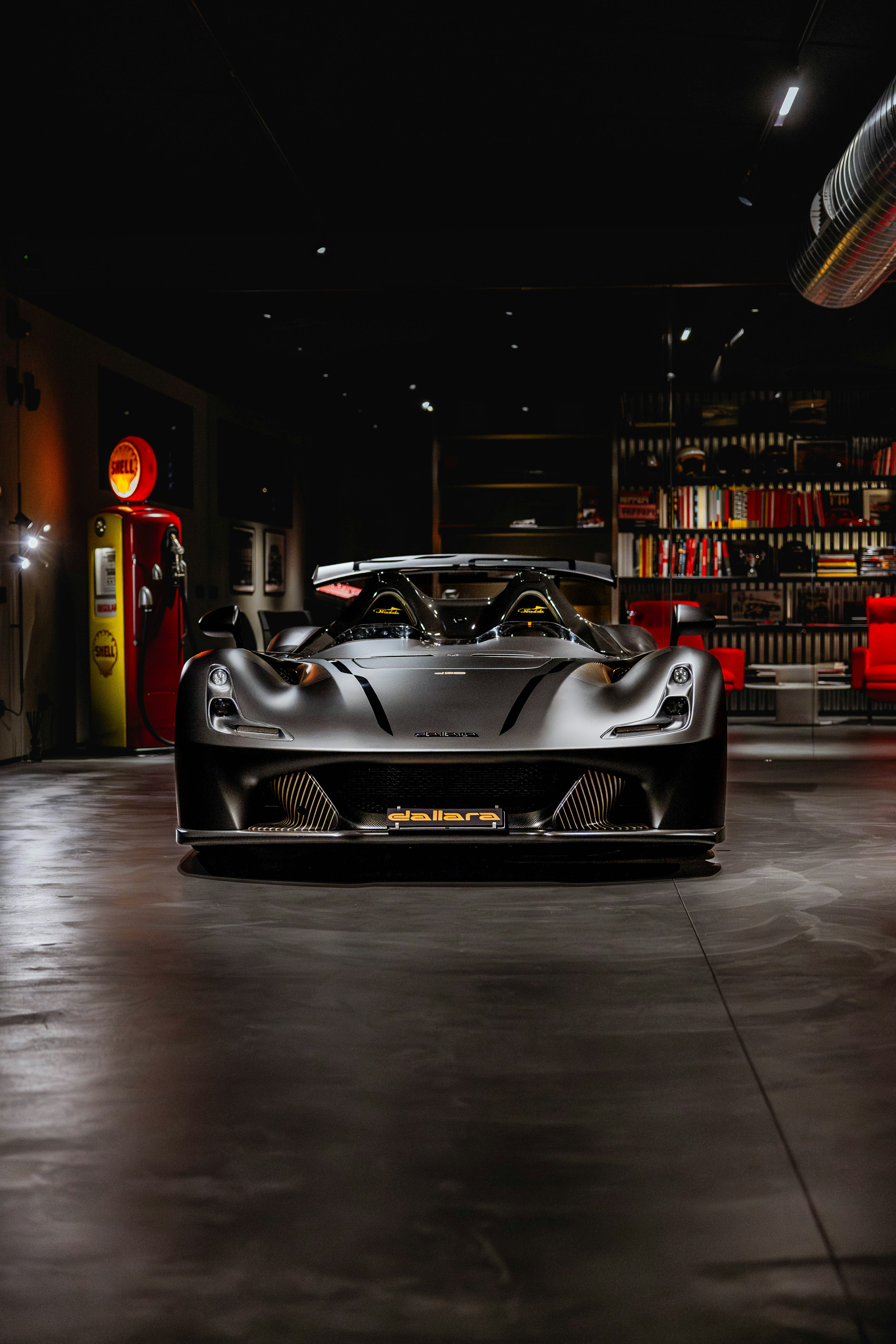 Sleek, modern sports car parked in a dimly lit garage.