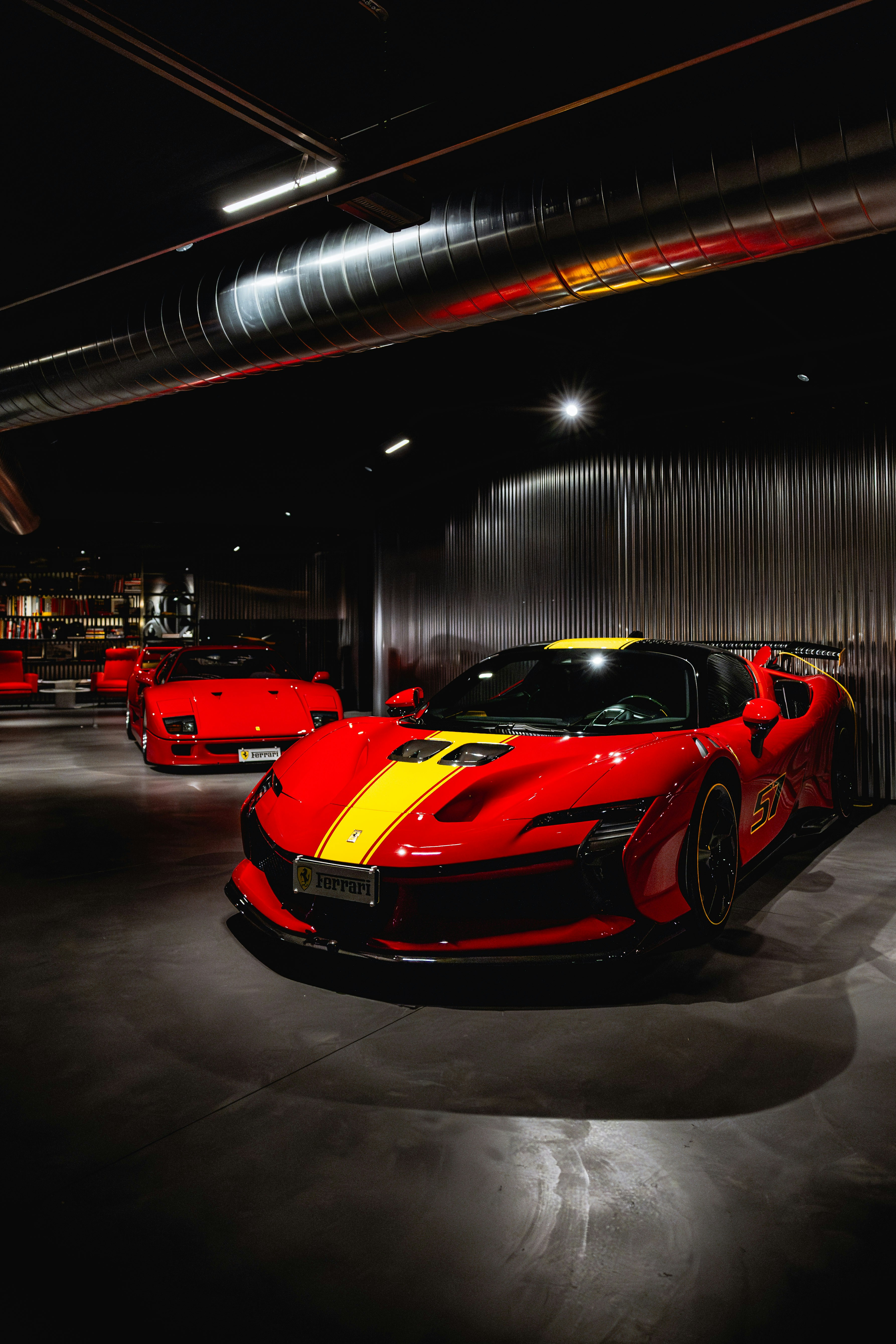 Red sports car with yellow stripes in showroom