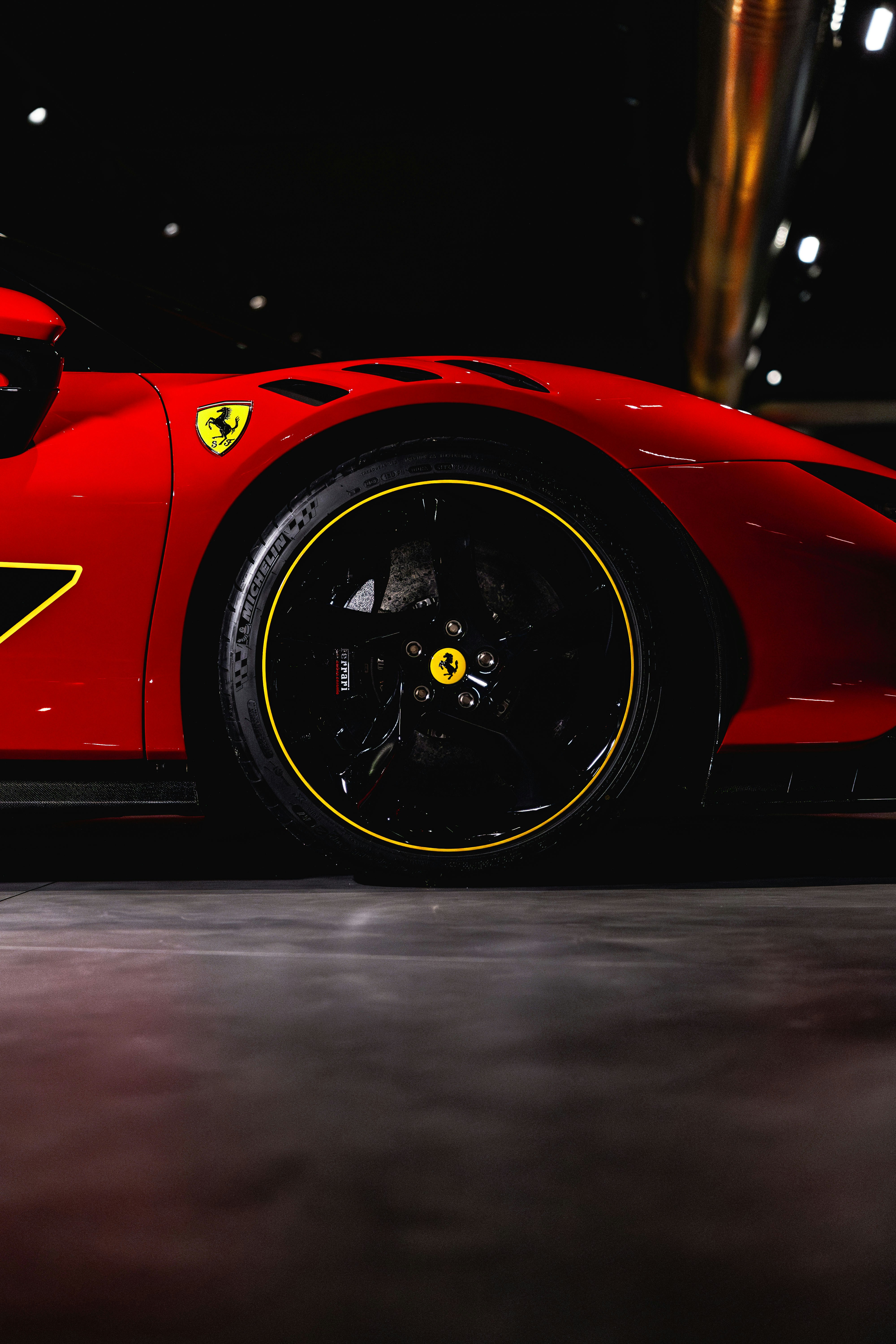 Red sports car with yellow trim on wheel