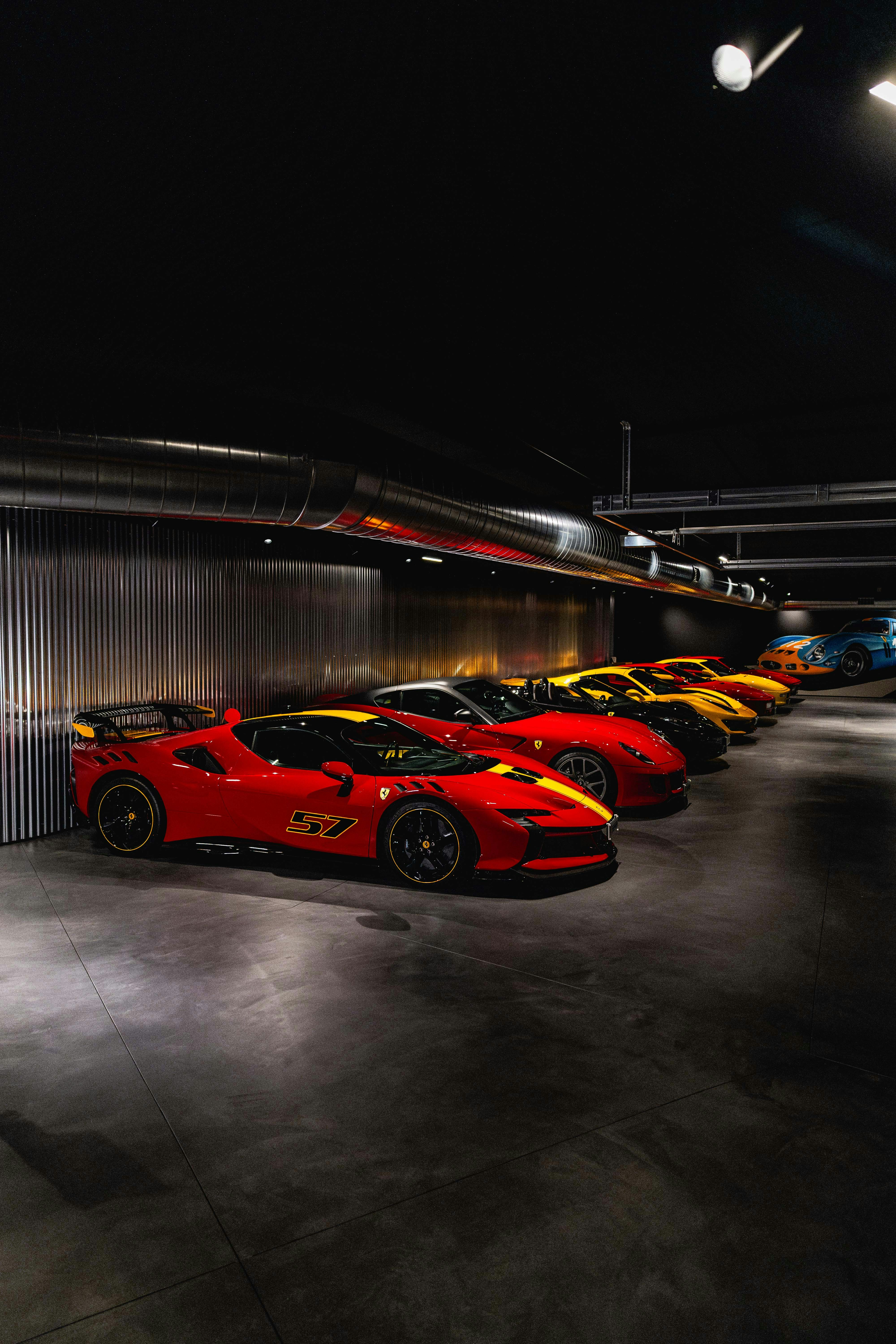 Several red sports cars parked in a row