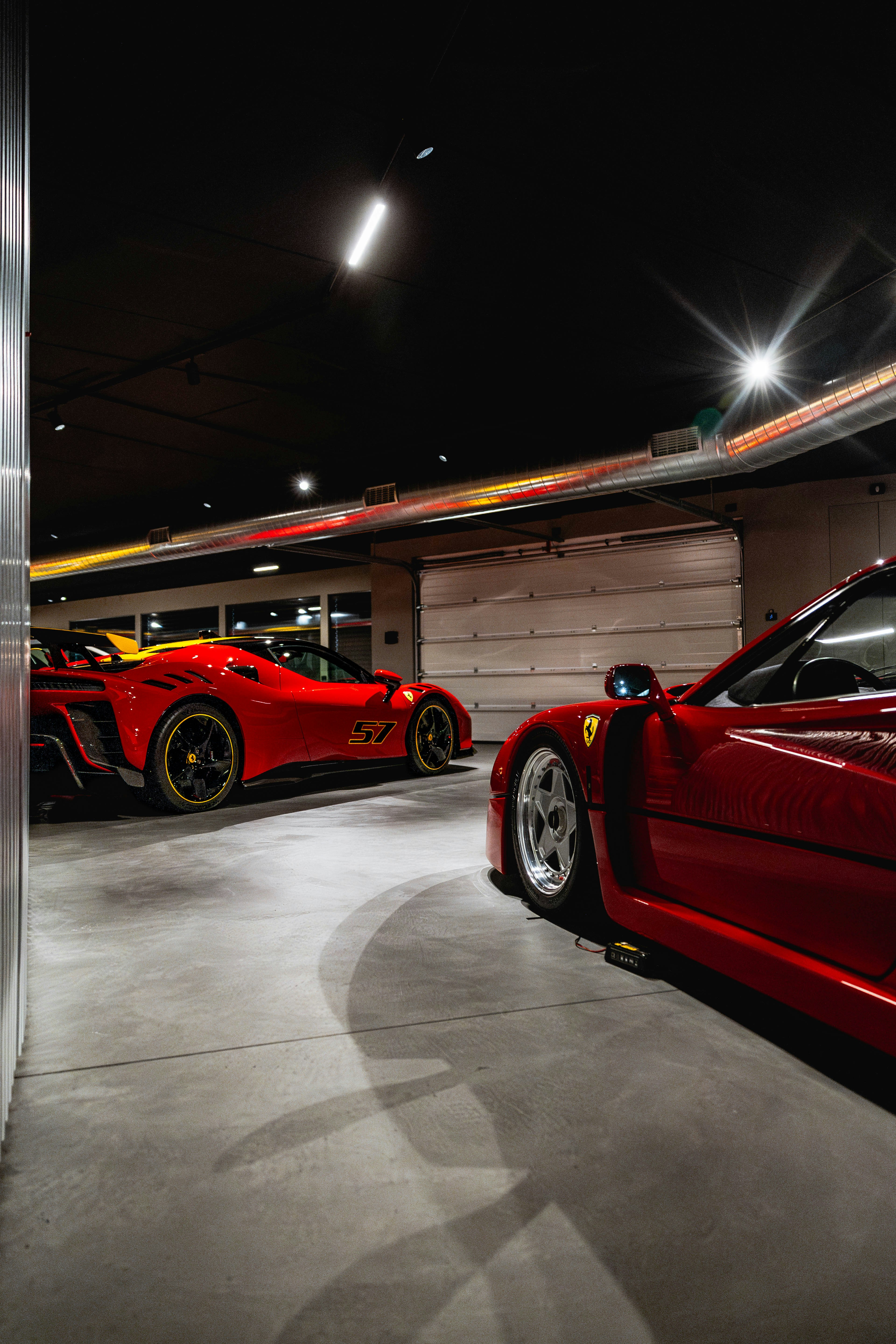 Several red sports cars parked indoors.
