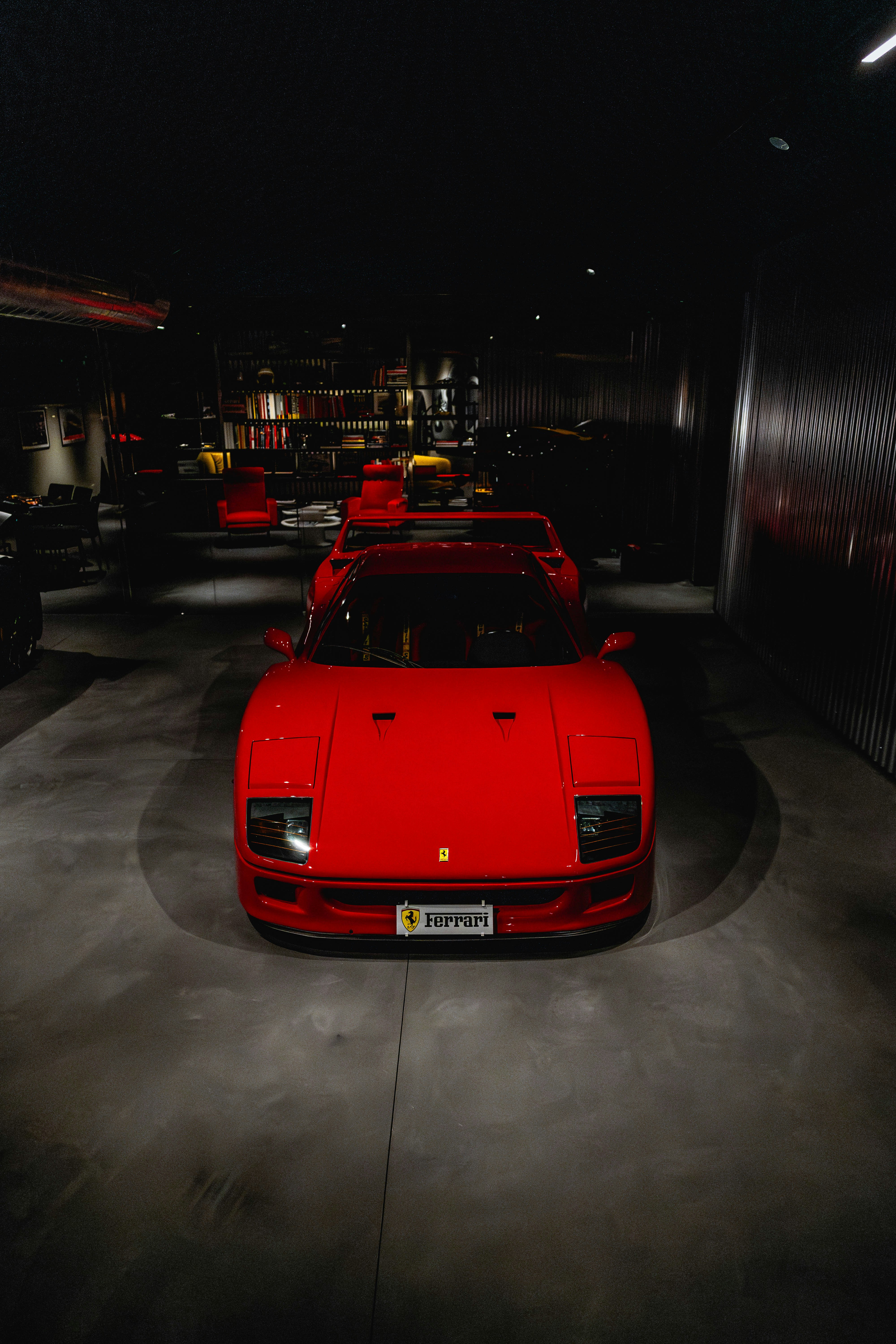 A red ferrari sports car parked indoors.