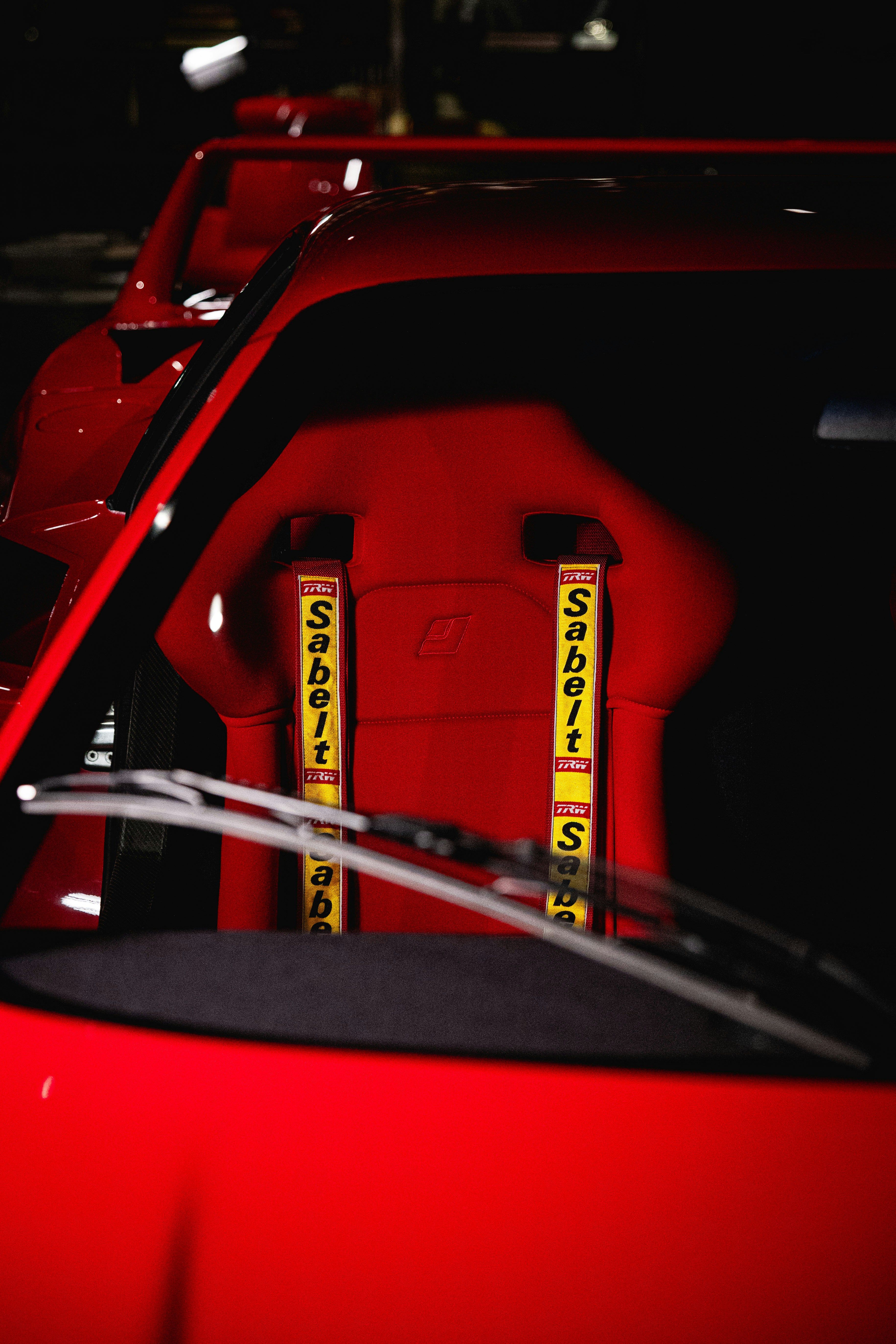 Red racing car interior with sabelt harness