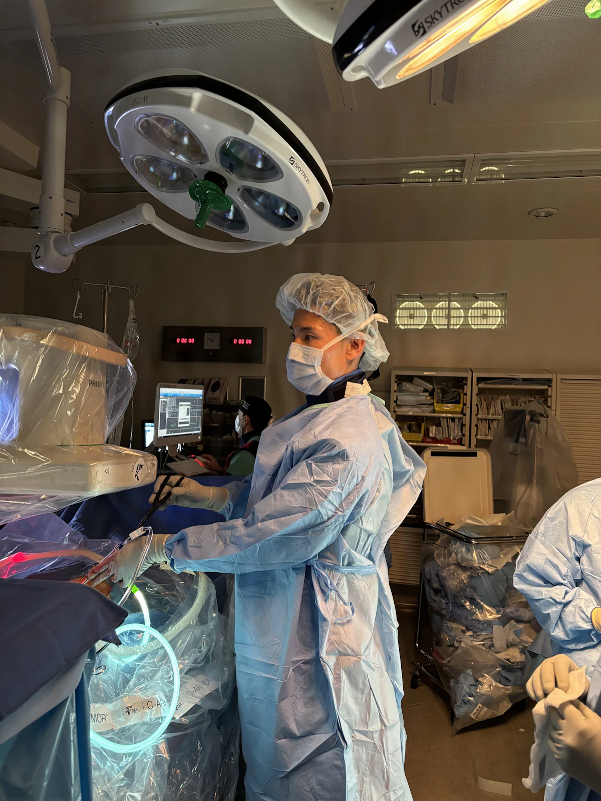 U.S. surgeon in sterile gown and mask in an operating room
