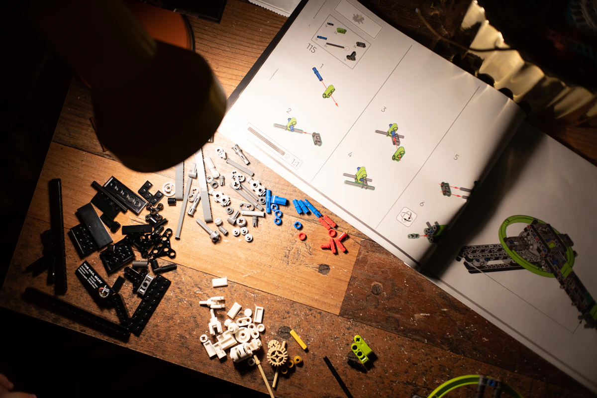 Building instructions and scattered LEGO bricks on wooden table