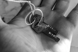 Two keys tied together resting in a palm