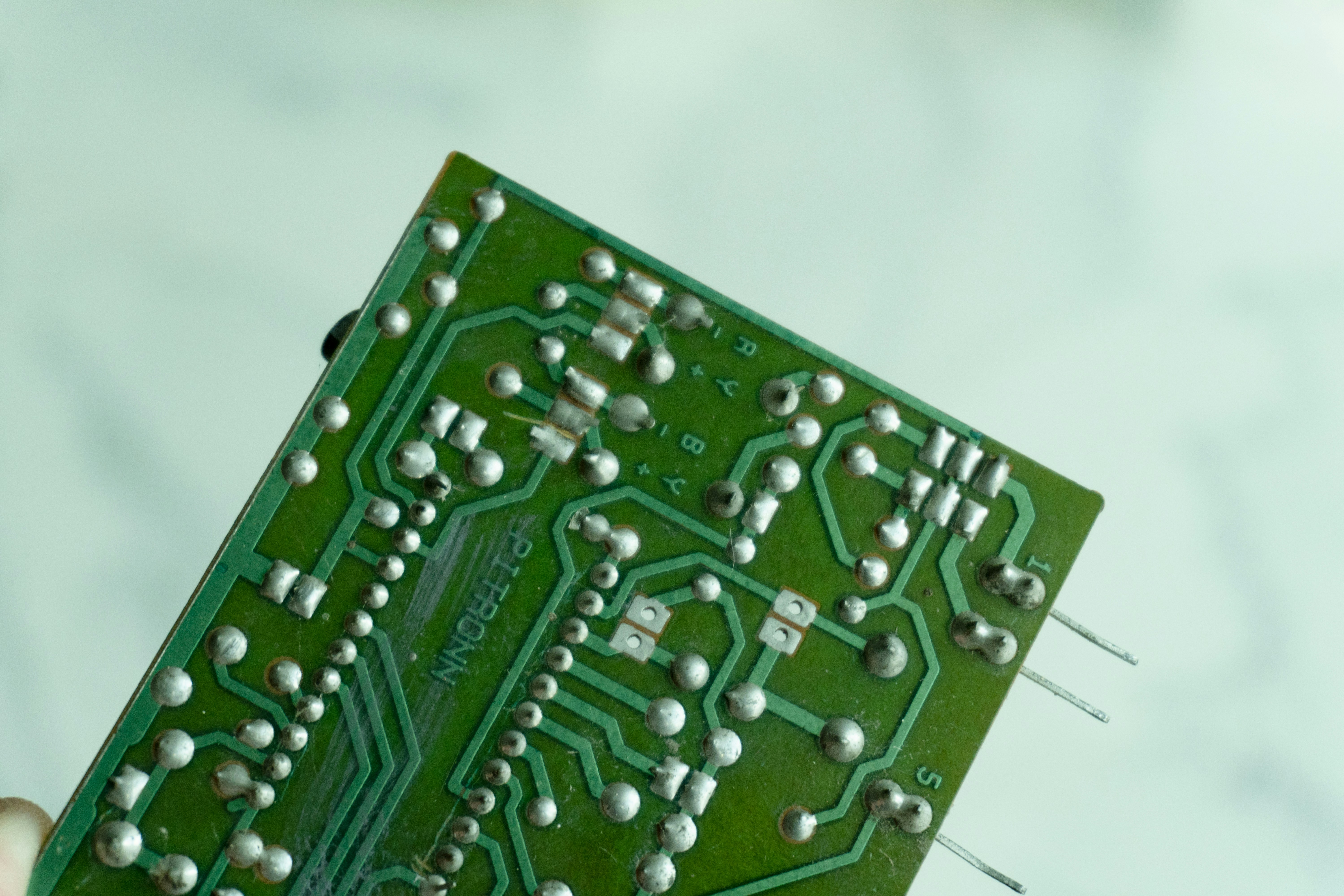 Close-up of a green circuit board with many components.