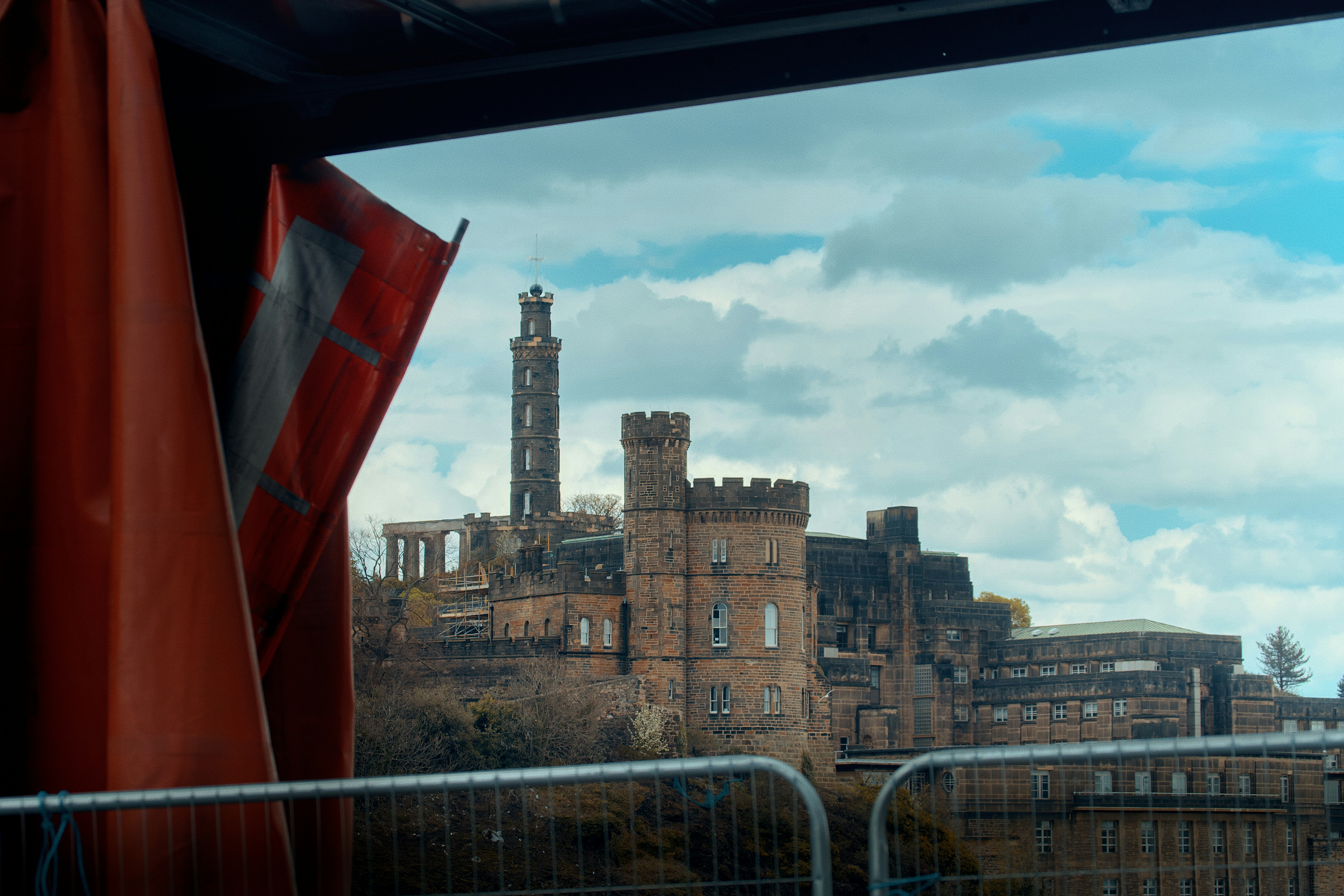 Historic castle and monument under cloudy sky