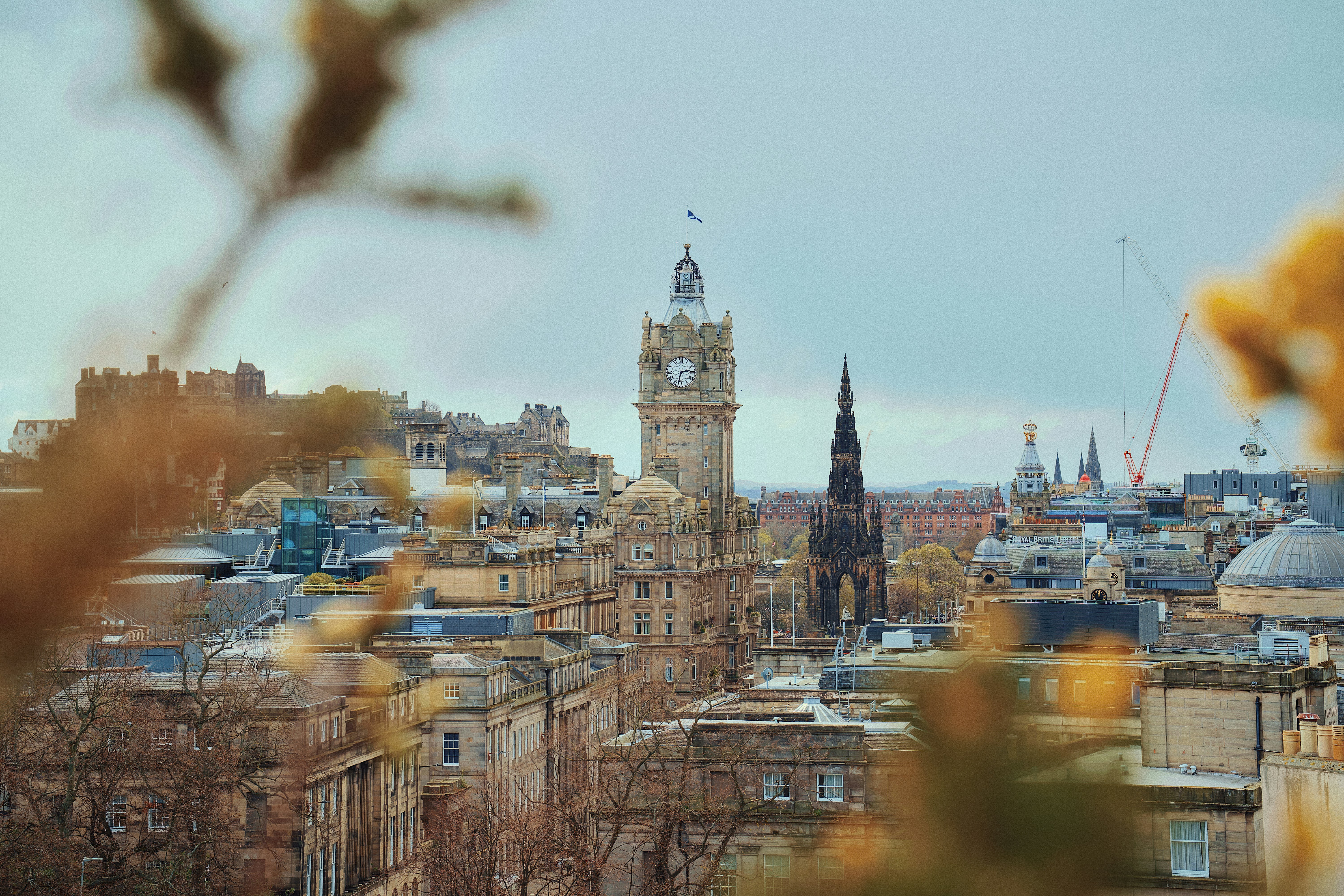 Edinburgh cityscape with historic buildings and clock tower.