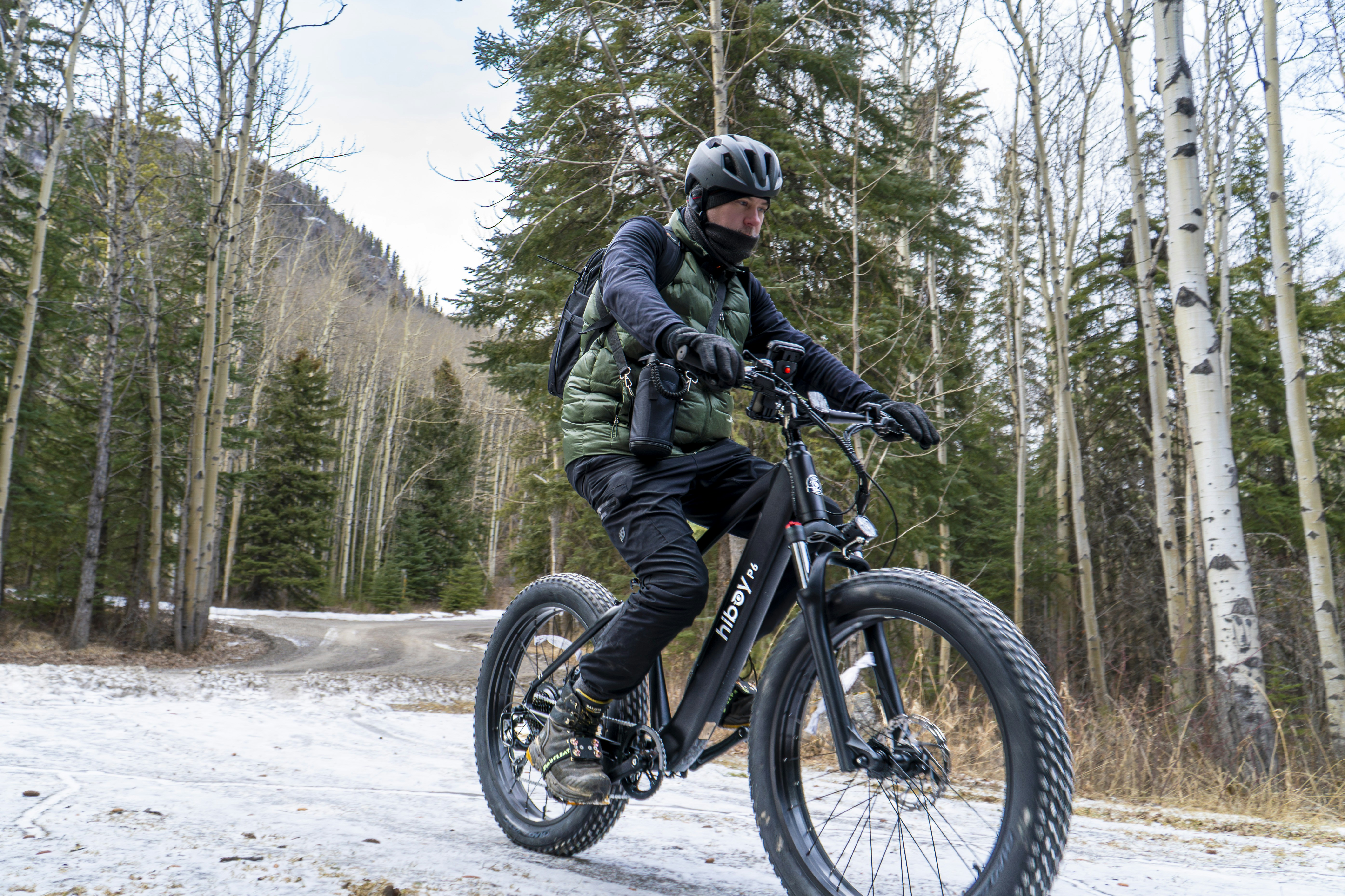 Man riding electric fat tire bike in snowy forest