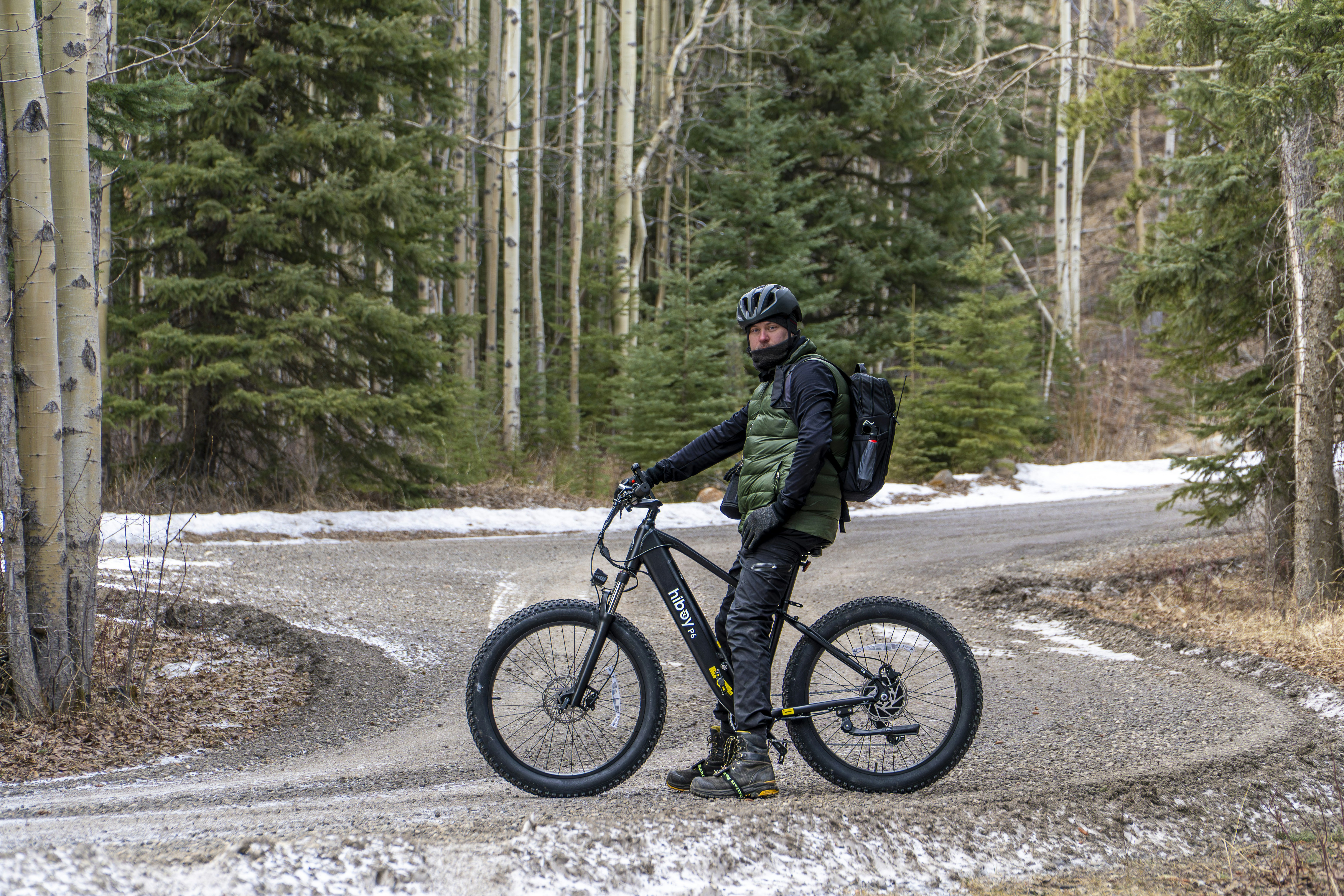 Man with fat tire bike on snowy forest road