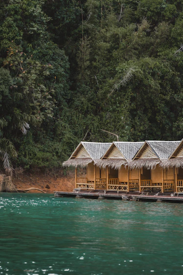 Row of bamboo huts on a turquoise lake