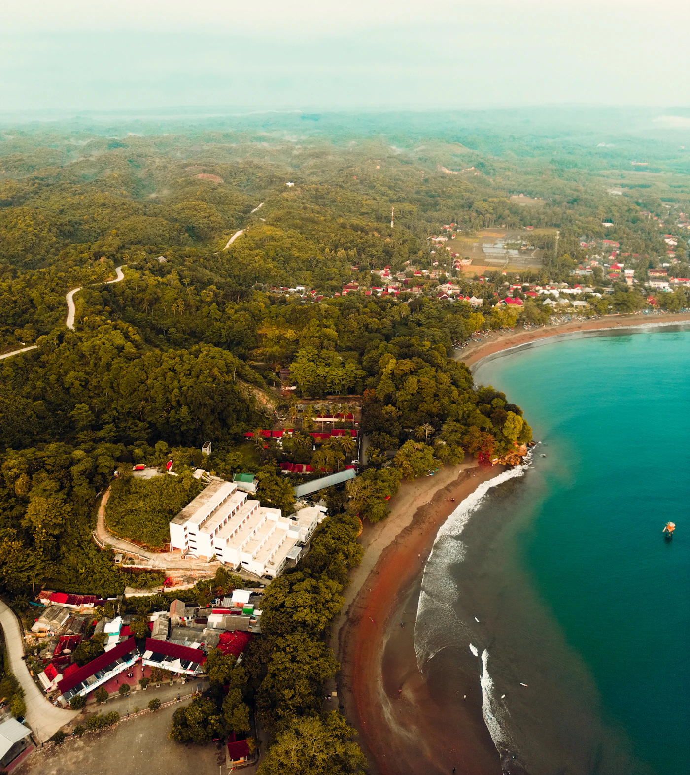 Aerial view of a coastal Panama town in green hills