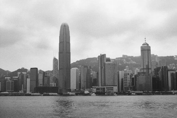 Modern skyscrapers rise above a calm body of water.