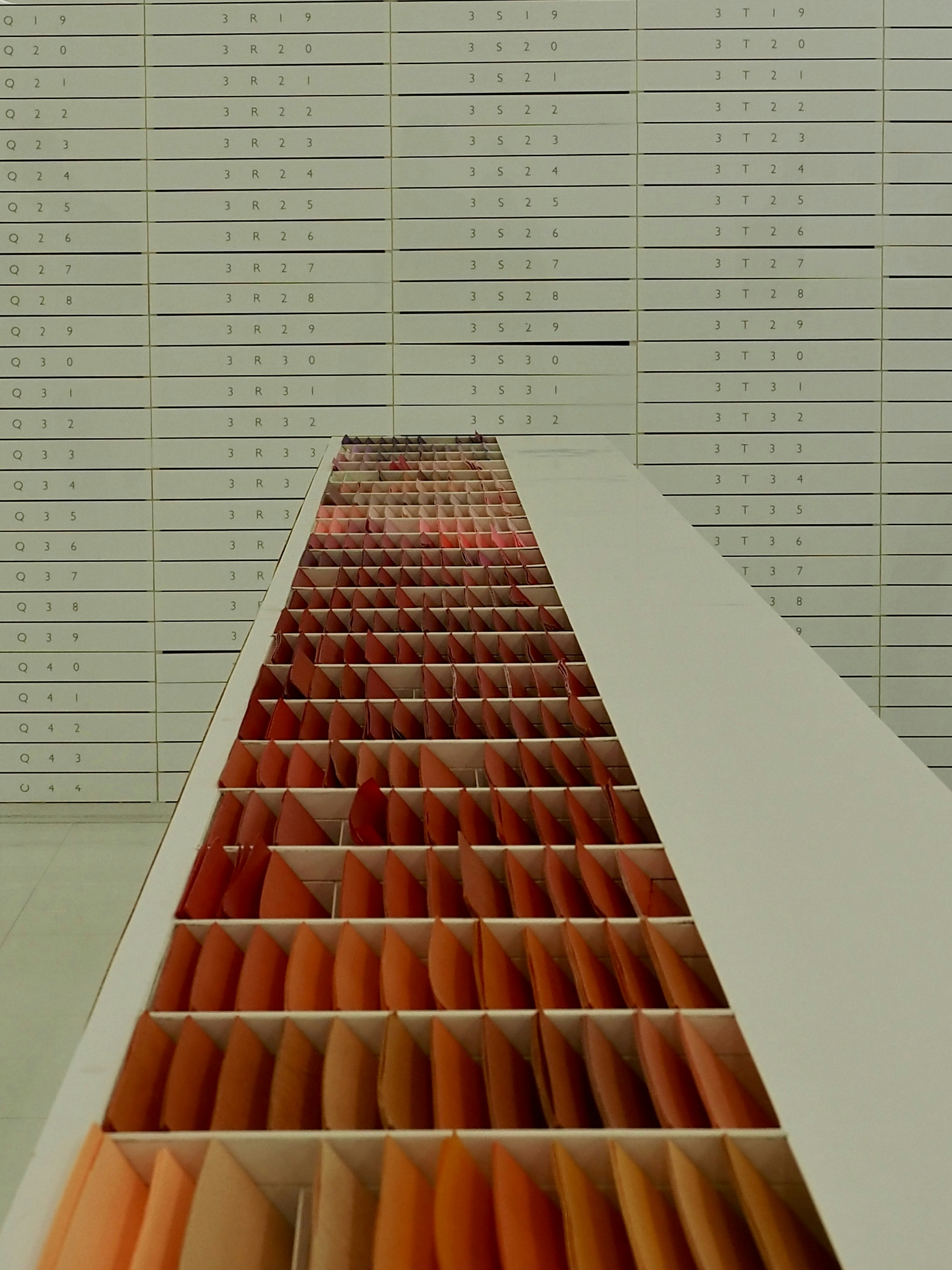 Rows of orange and red swatches in a display.