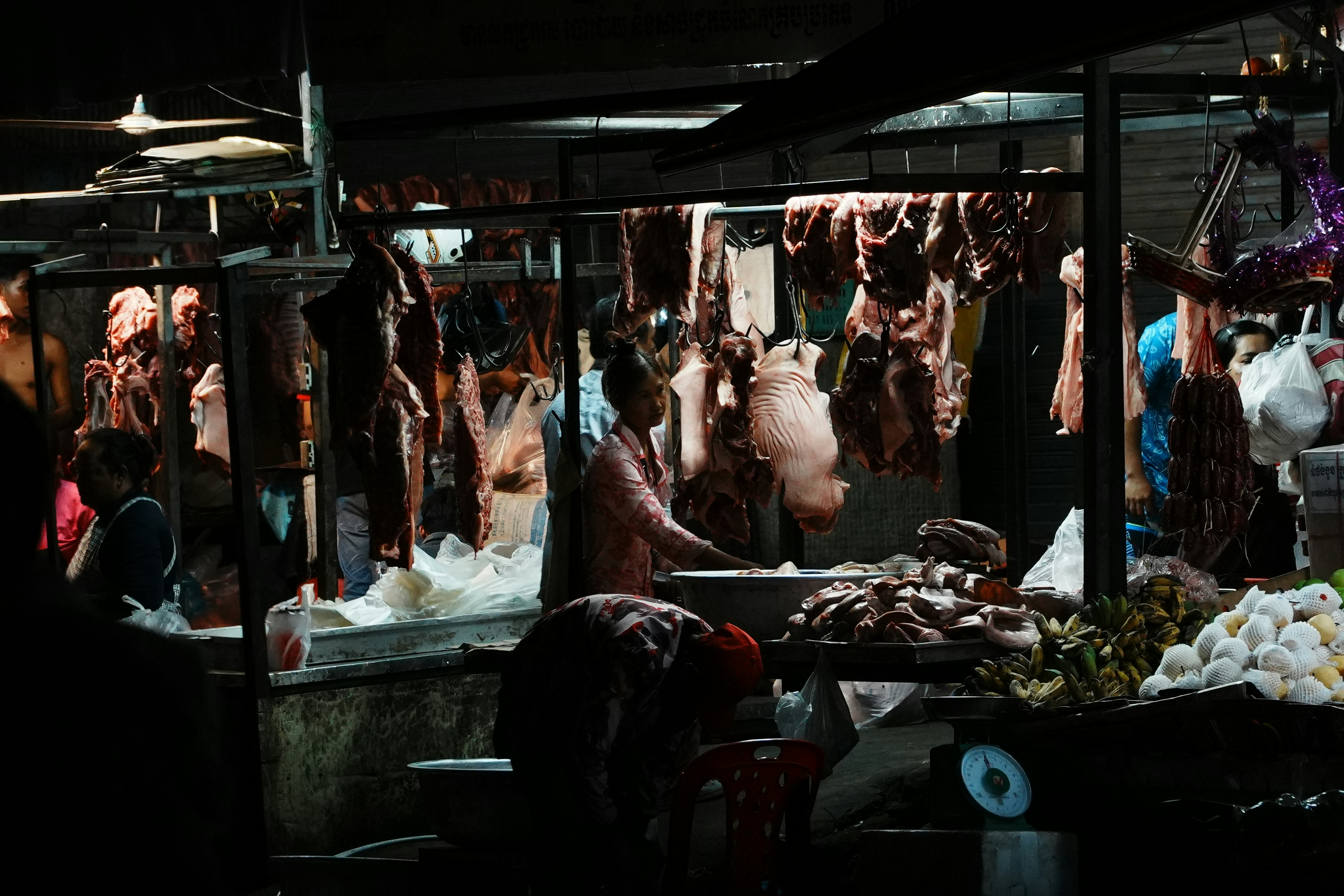 Butcher stall with hanging meats and produce