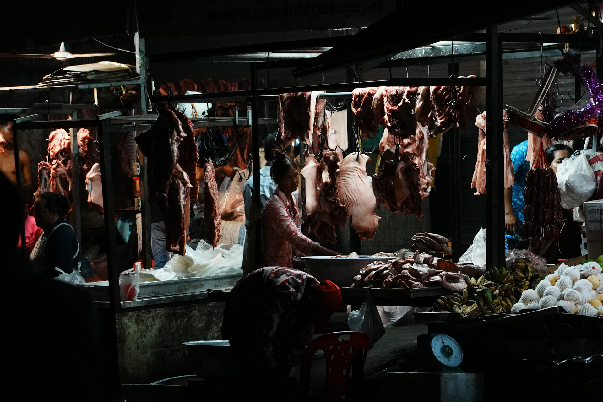 Butcher stall with hanging meats and produce