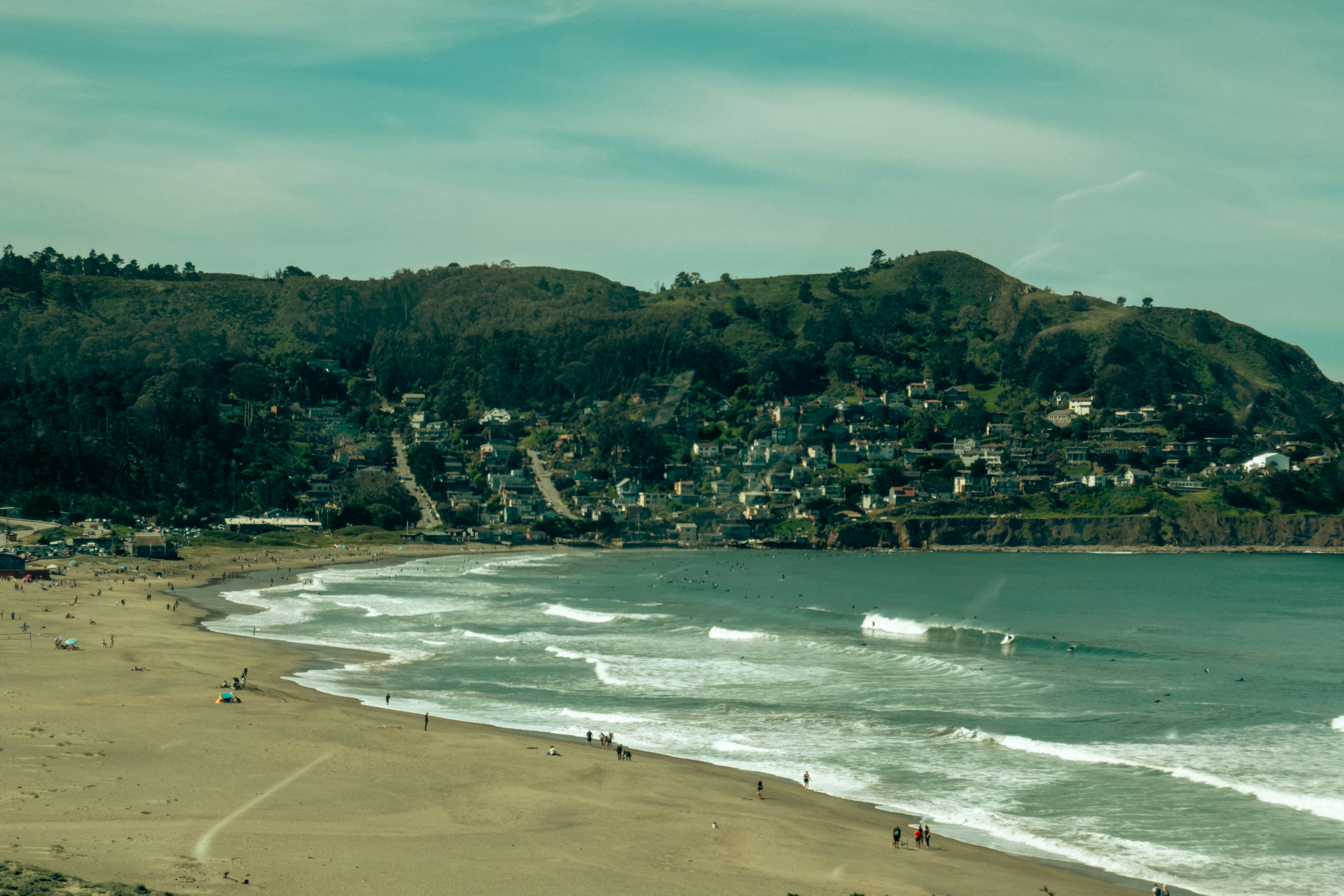 Serene lake reflecting a clear blue sky and surrounding greenery.