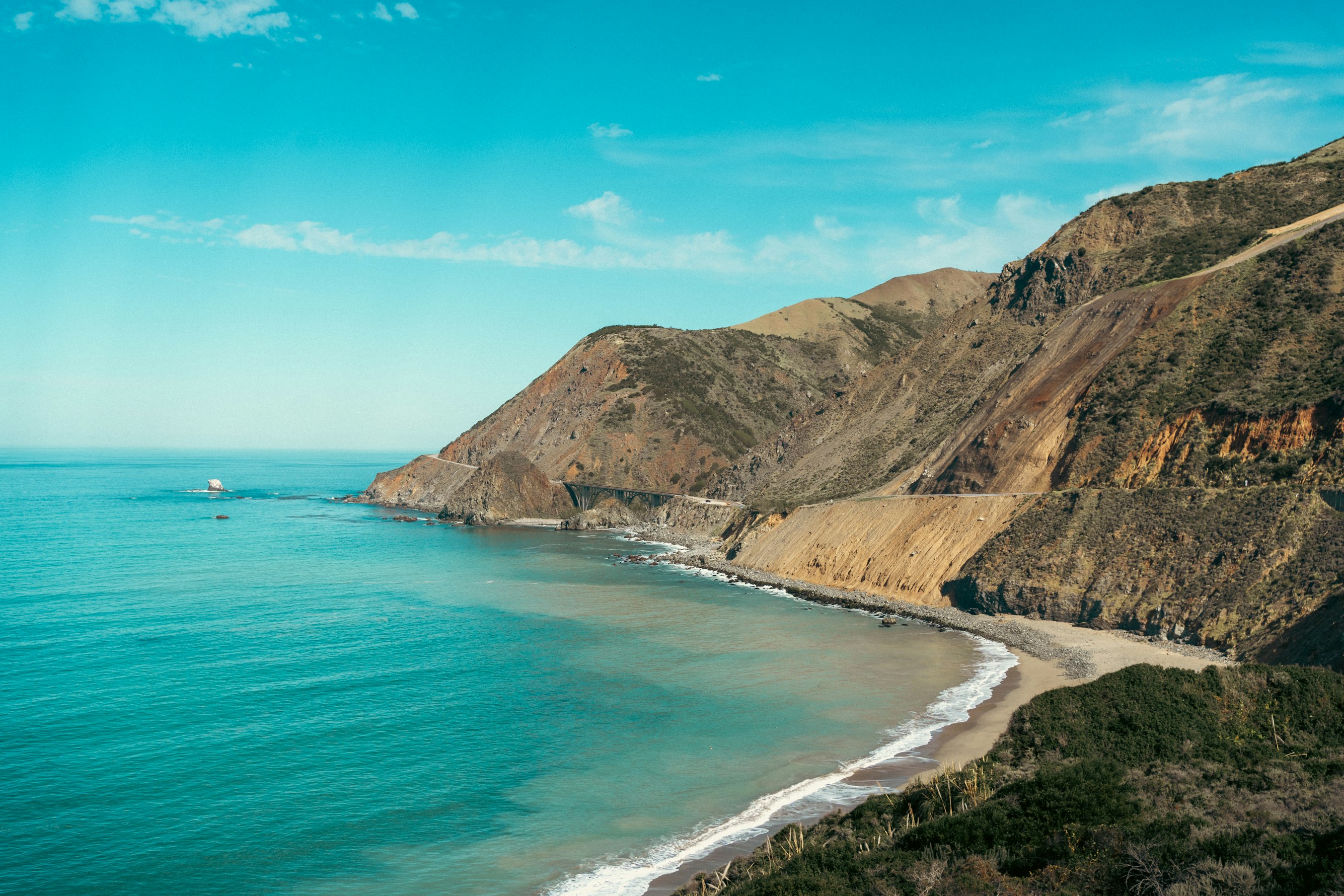 A view of the sea and distant hills framed perfectly through a stone archway
