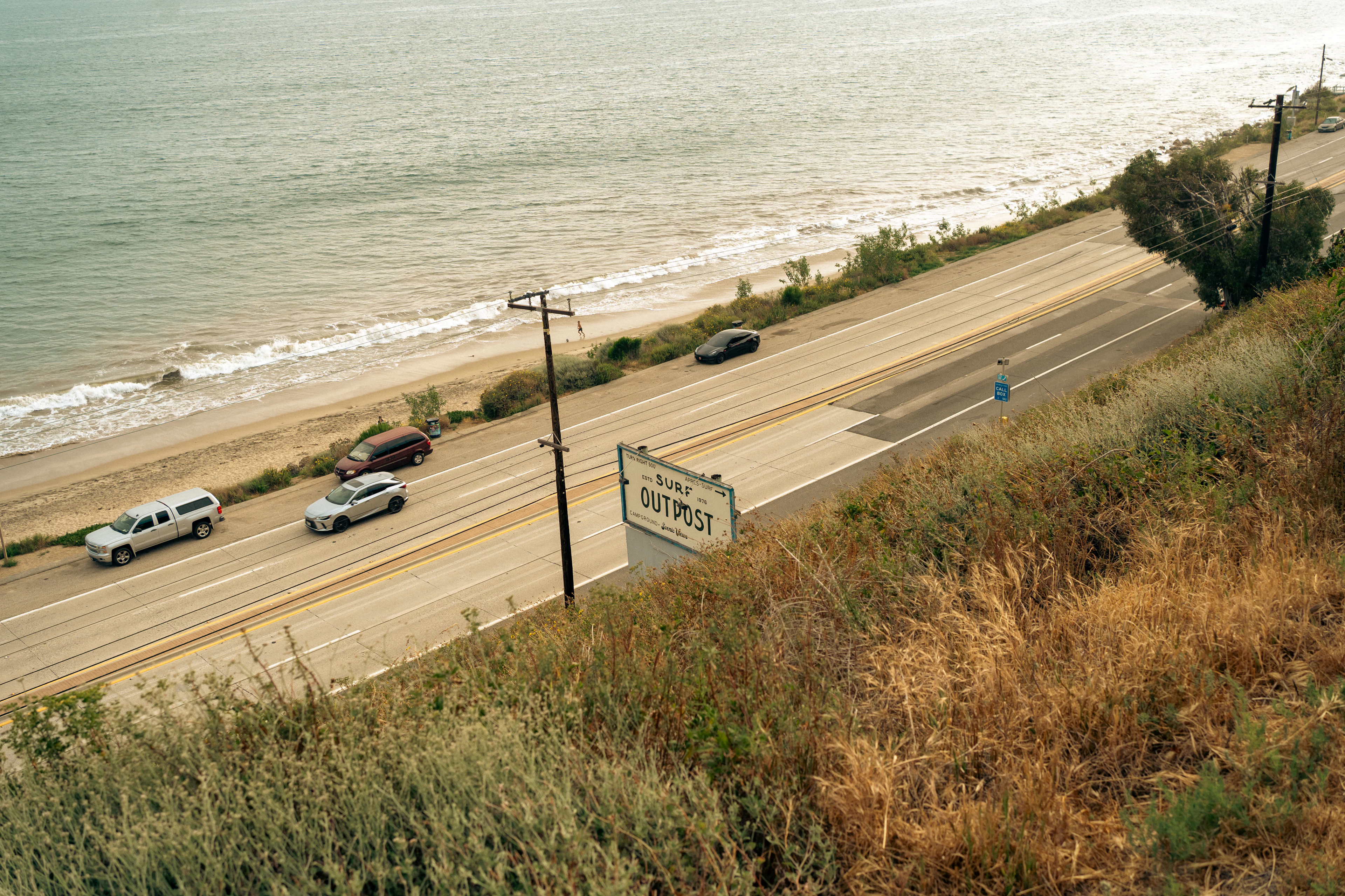 Cars driving along a scenic coastal highway