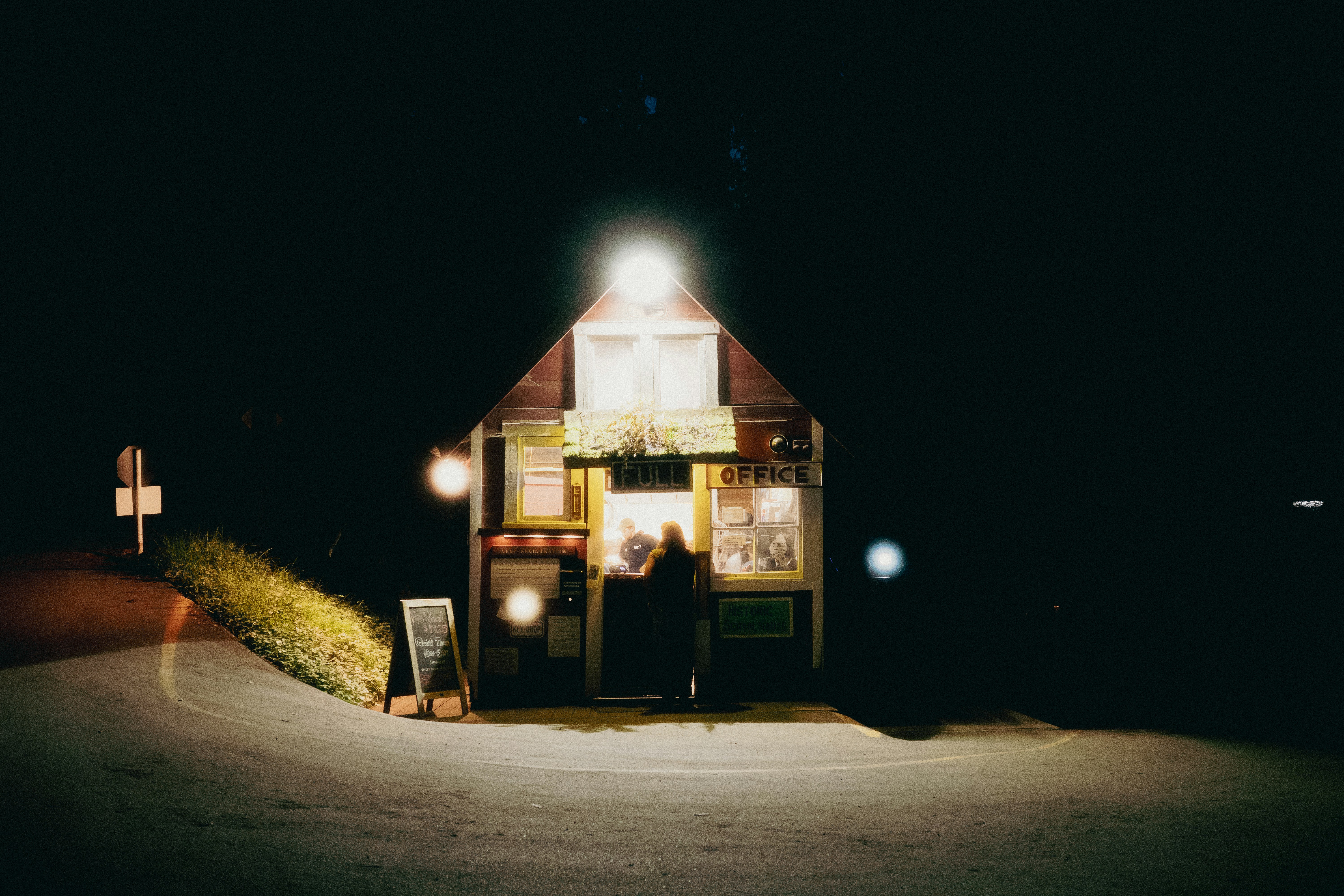 Waves crashing against a rocky shoreline under a cloudy sky.