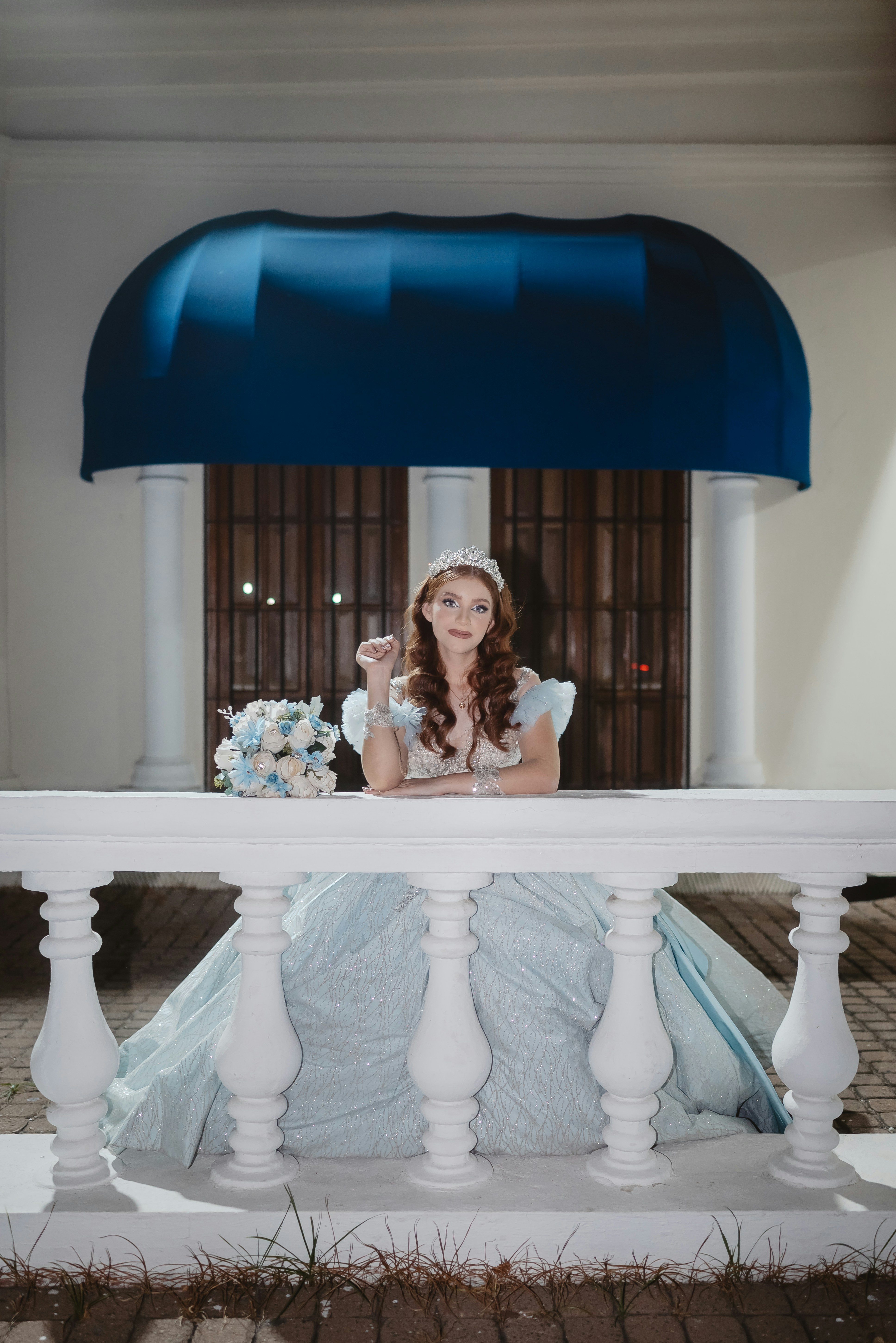Young woman in a light blue ball gown and tiara.