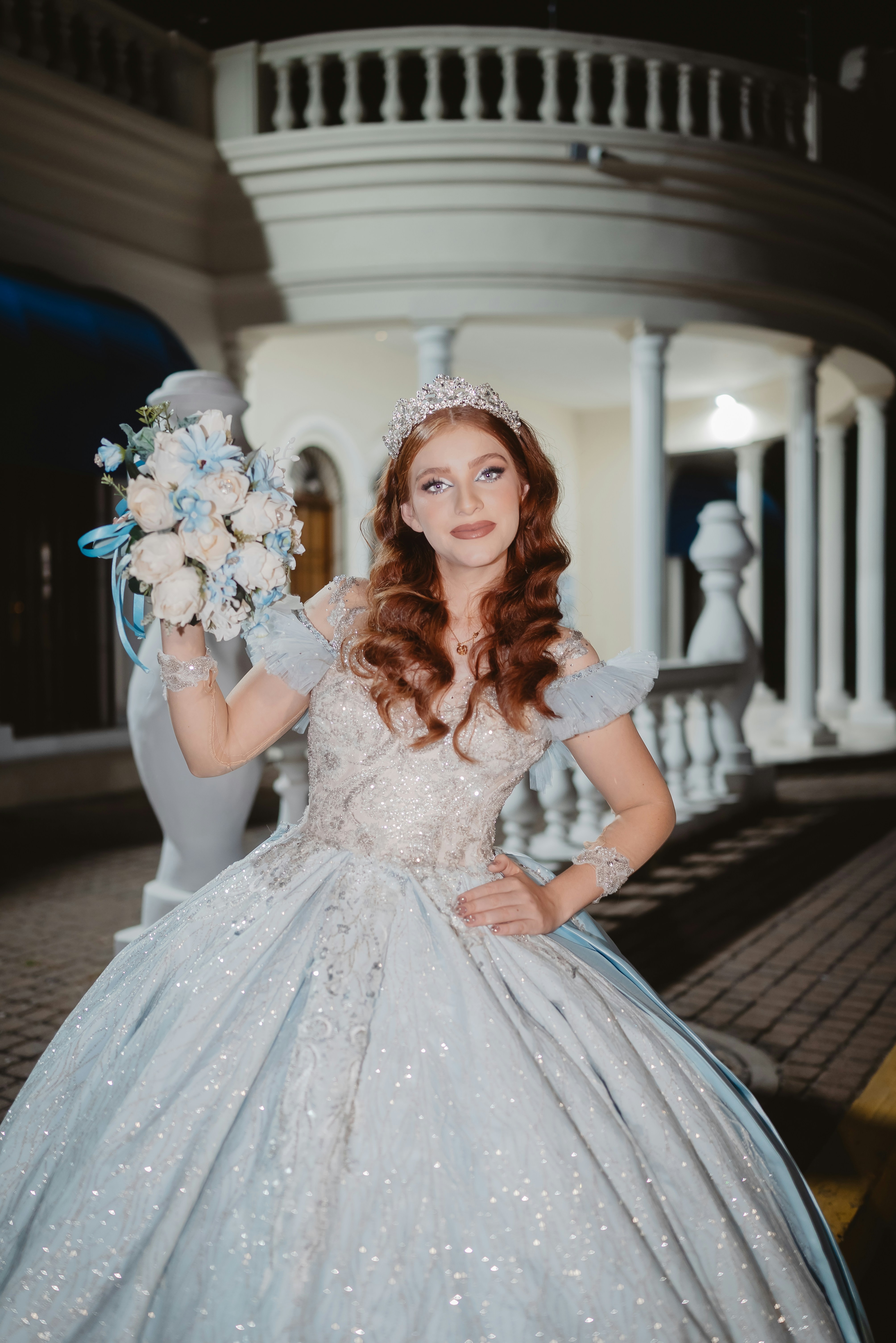 Young woman in a light blue ball gown and tiara