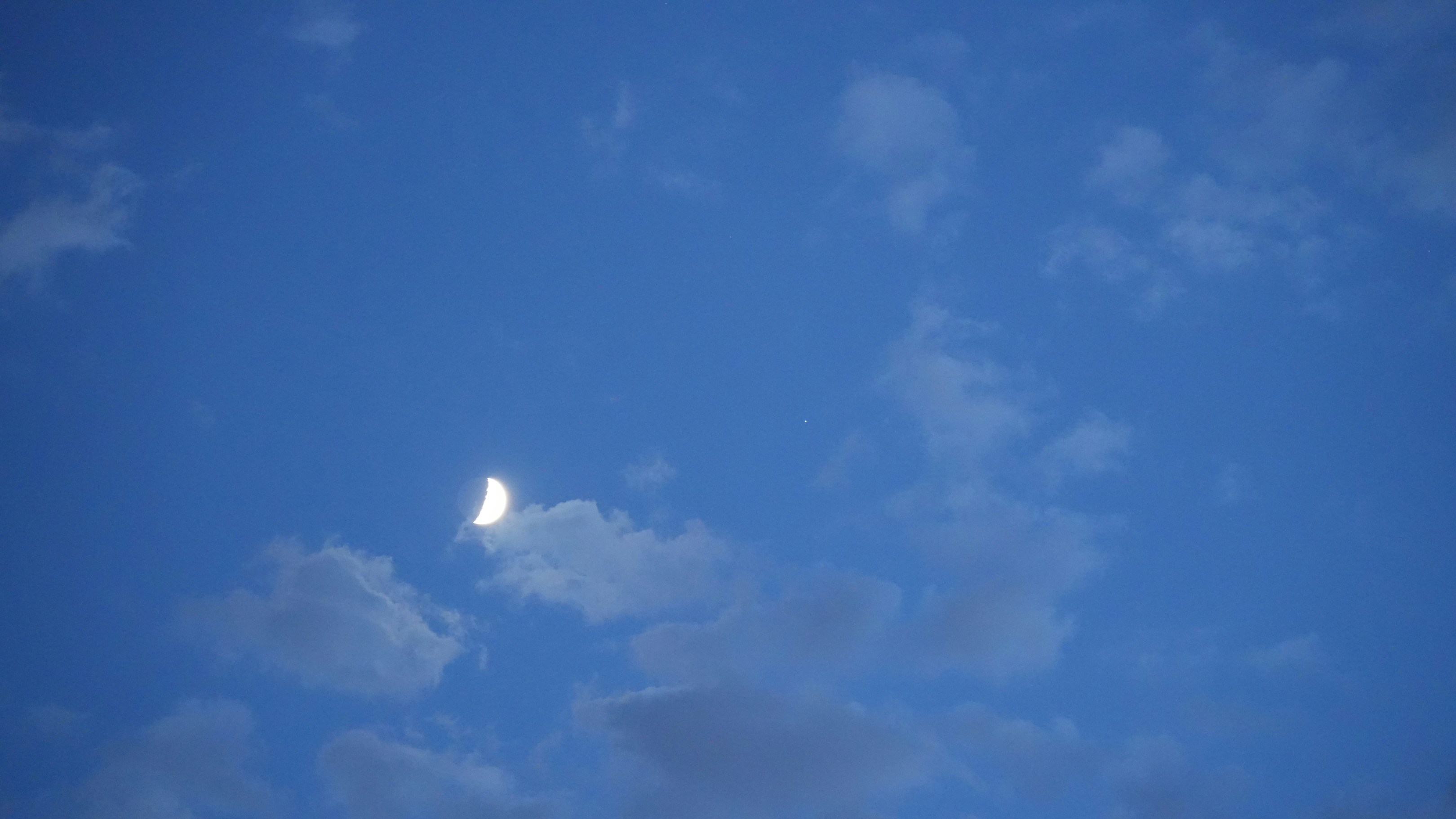 a crescent moon is visible in the sky