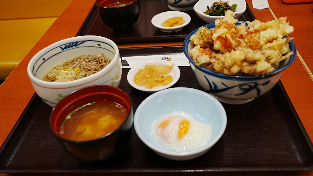 A Japanese tempura set with soba, rice, miso soup, pickles and a soft-cooked egg