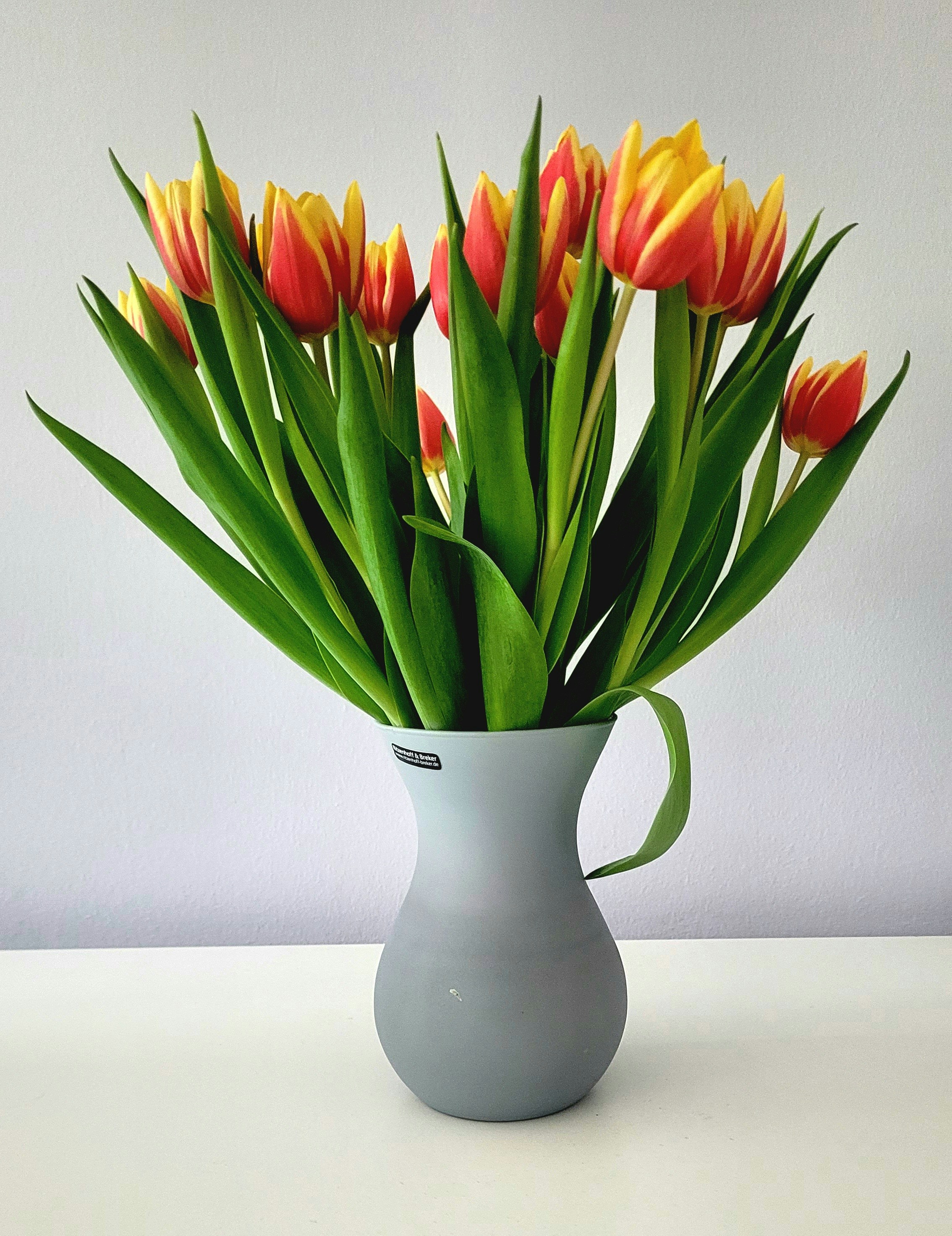 A vase of red and yellow tulips