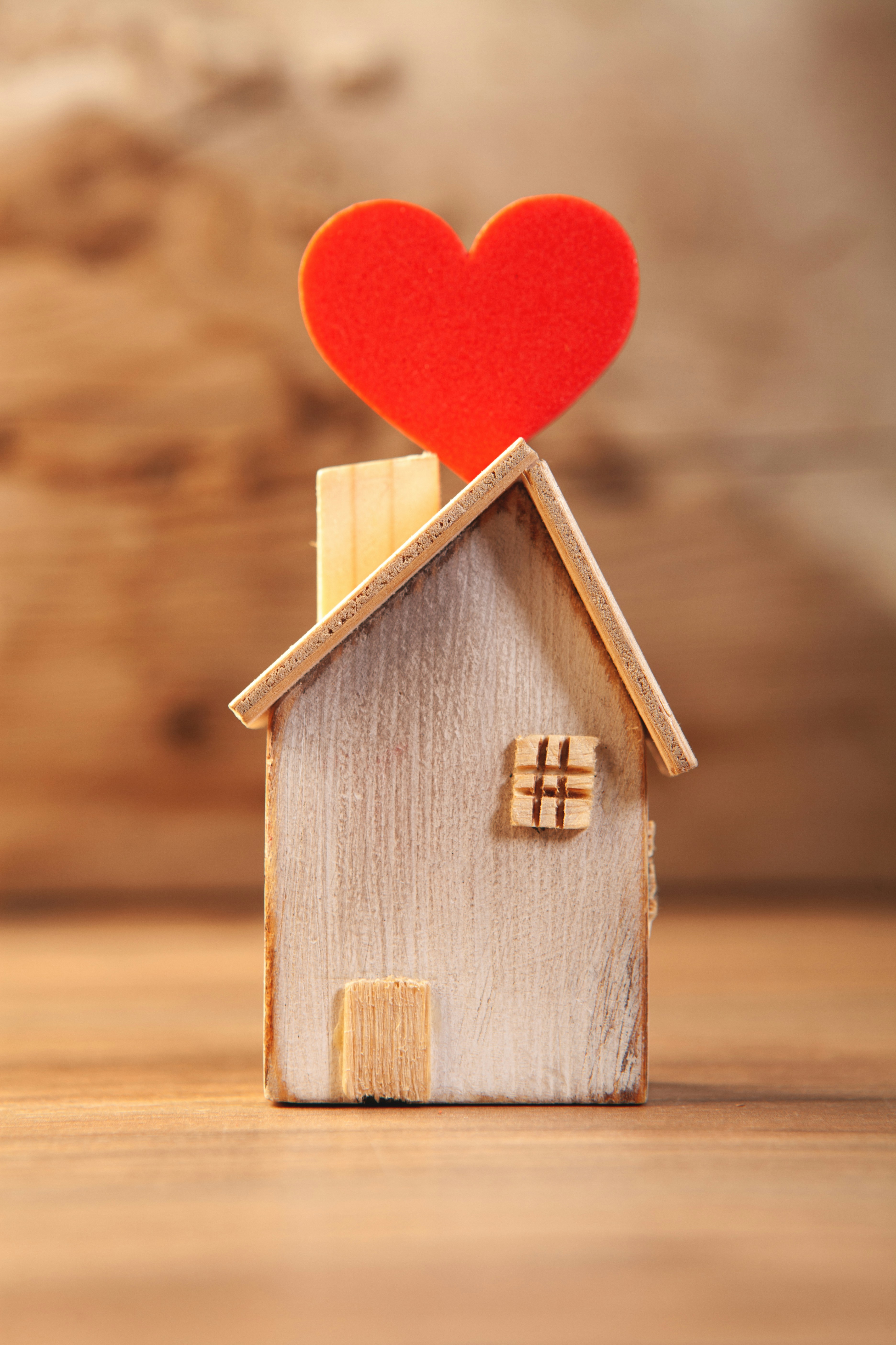 Wooden house with red heart on top