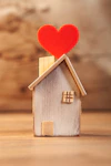 Wooden house with red heart on top