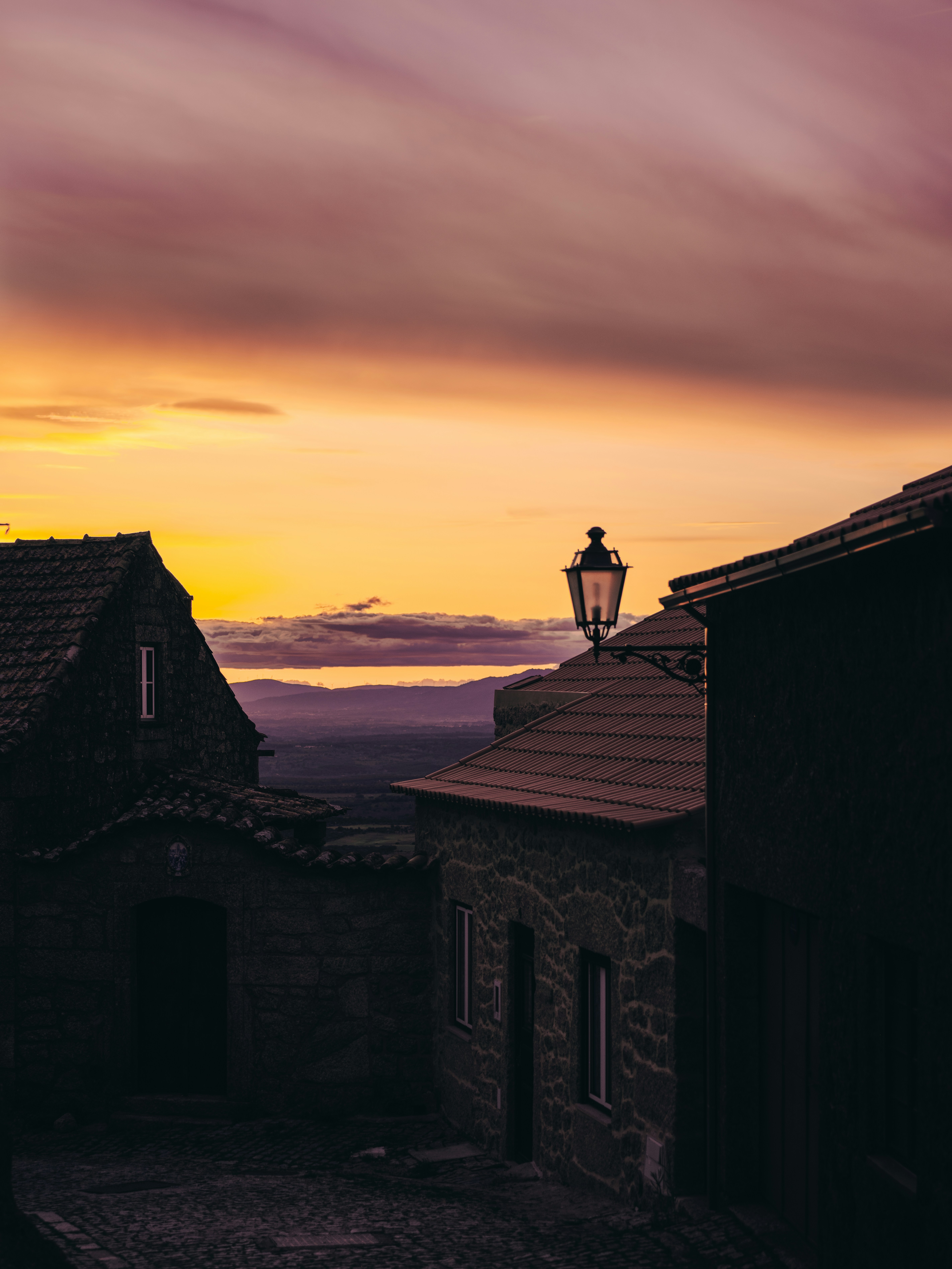 Stone houses and street lamp at sunset
