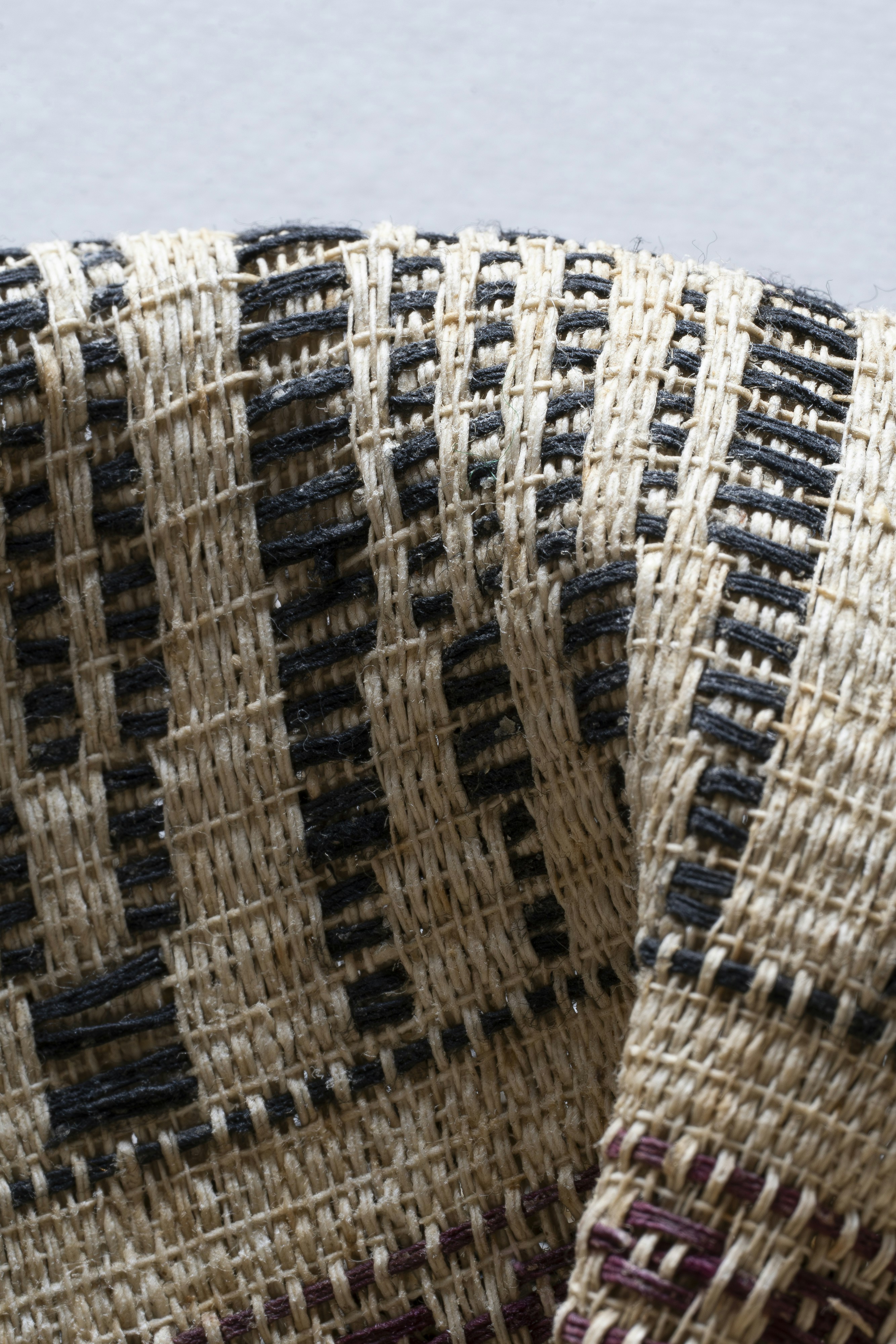 Primer plano de tela tejida con textura y patrones geométricos.