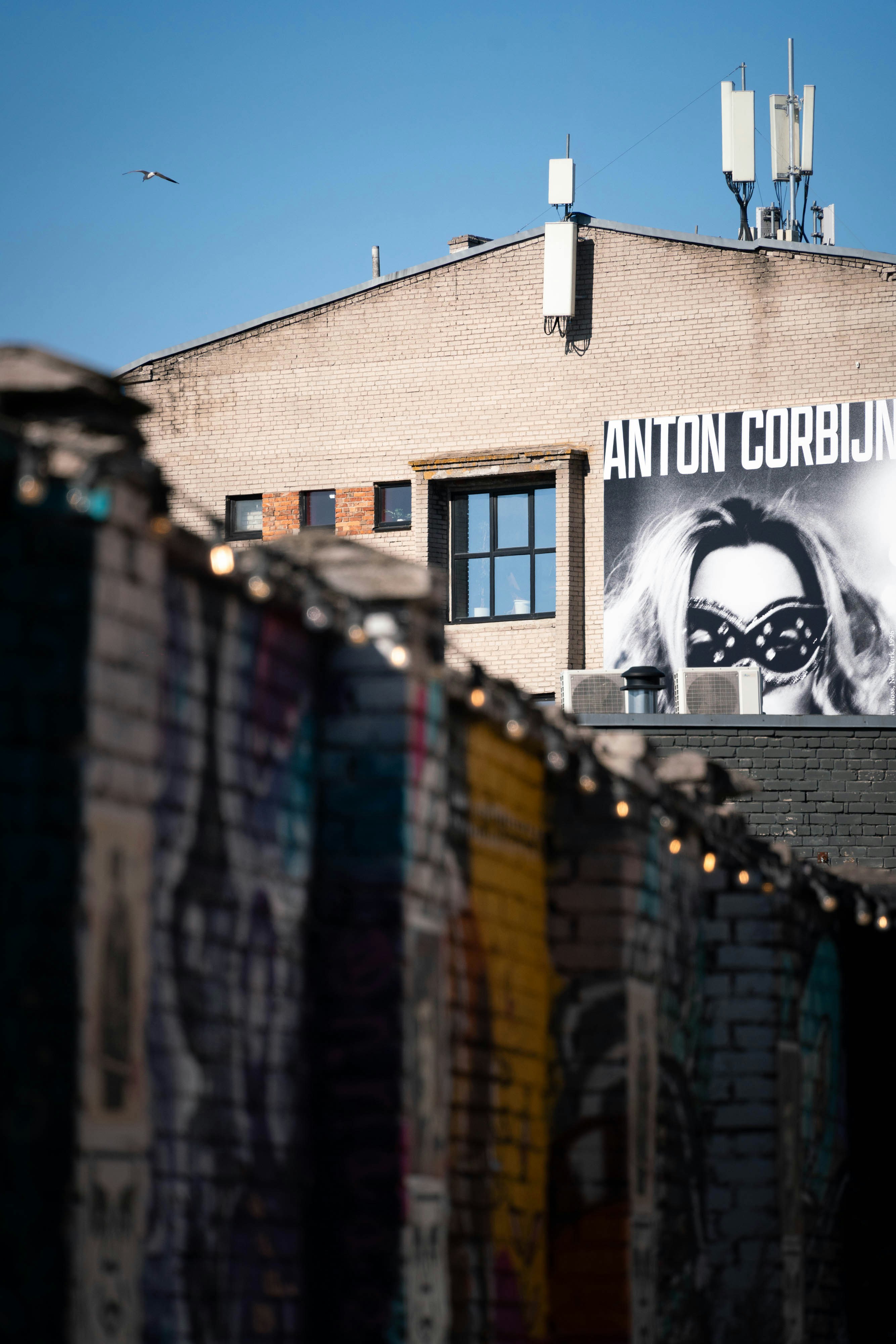 Edificio con anuncio de Antoin Corbijn y muro de grafitis