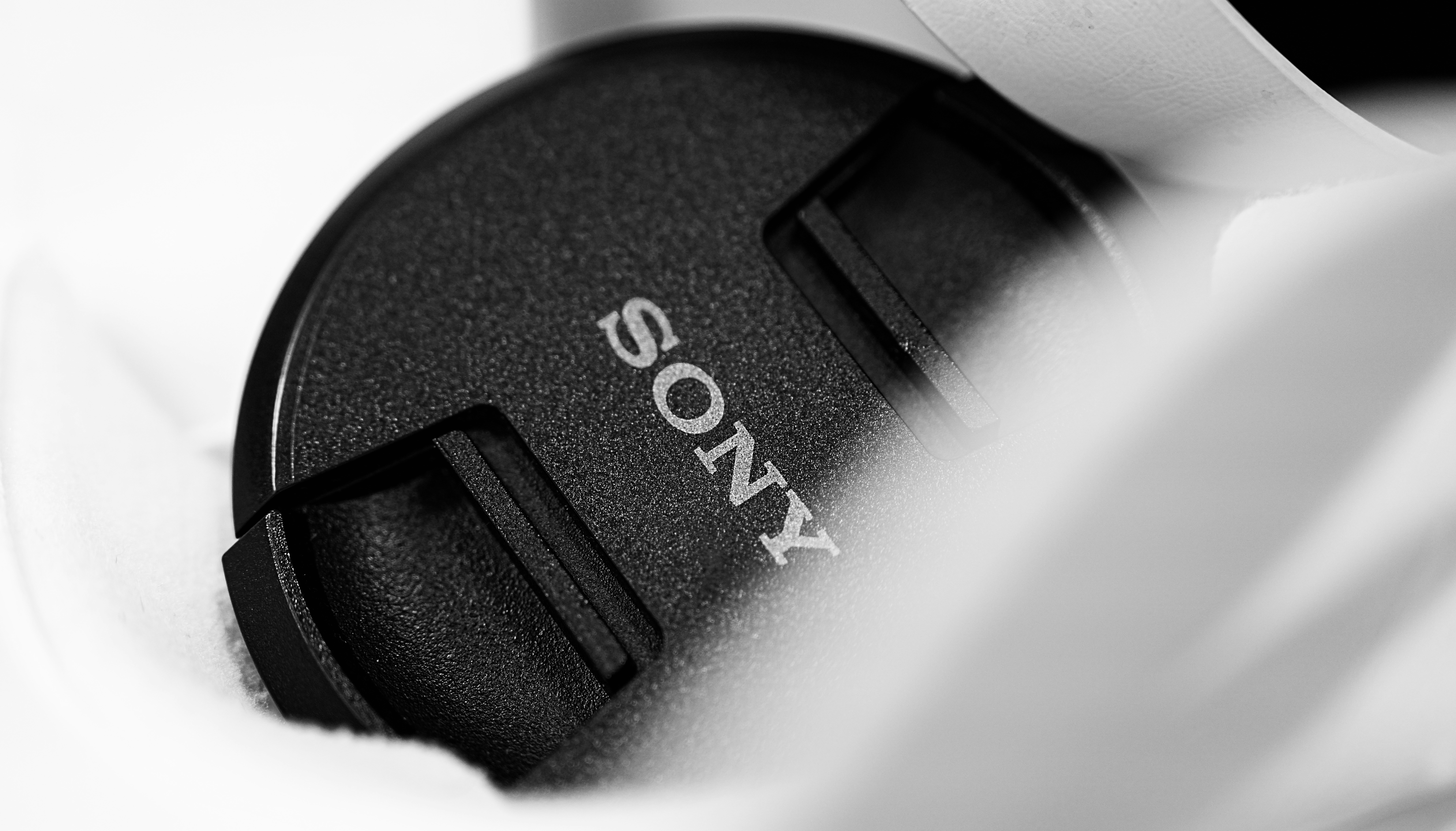 Sony lens cap held by hands