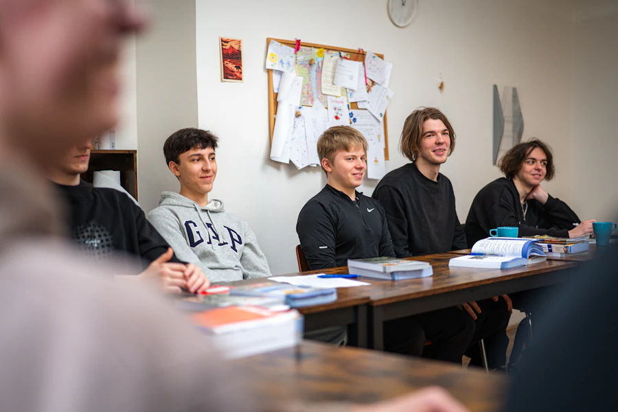 Students collaborating together at a table during a coaching session