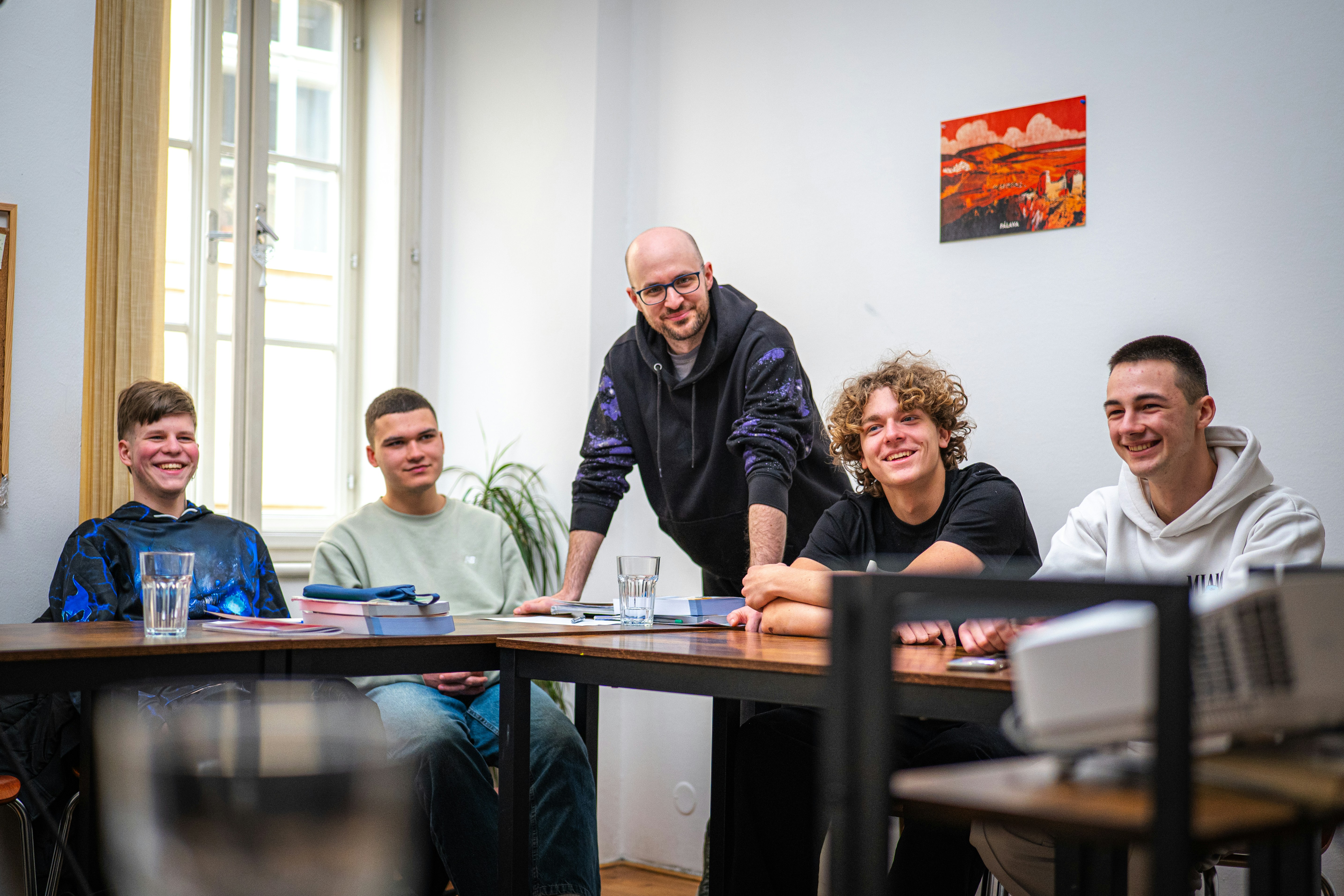 Group of young men and an adult at a table