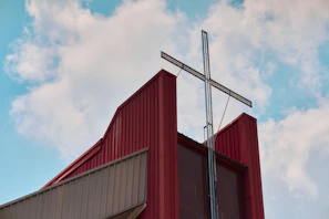 Modern church building with a large metal cross