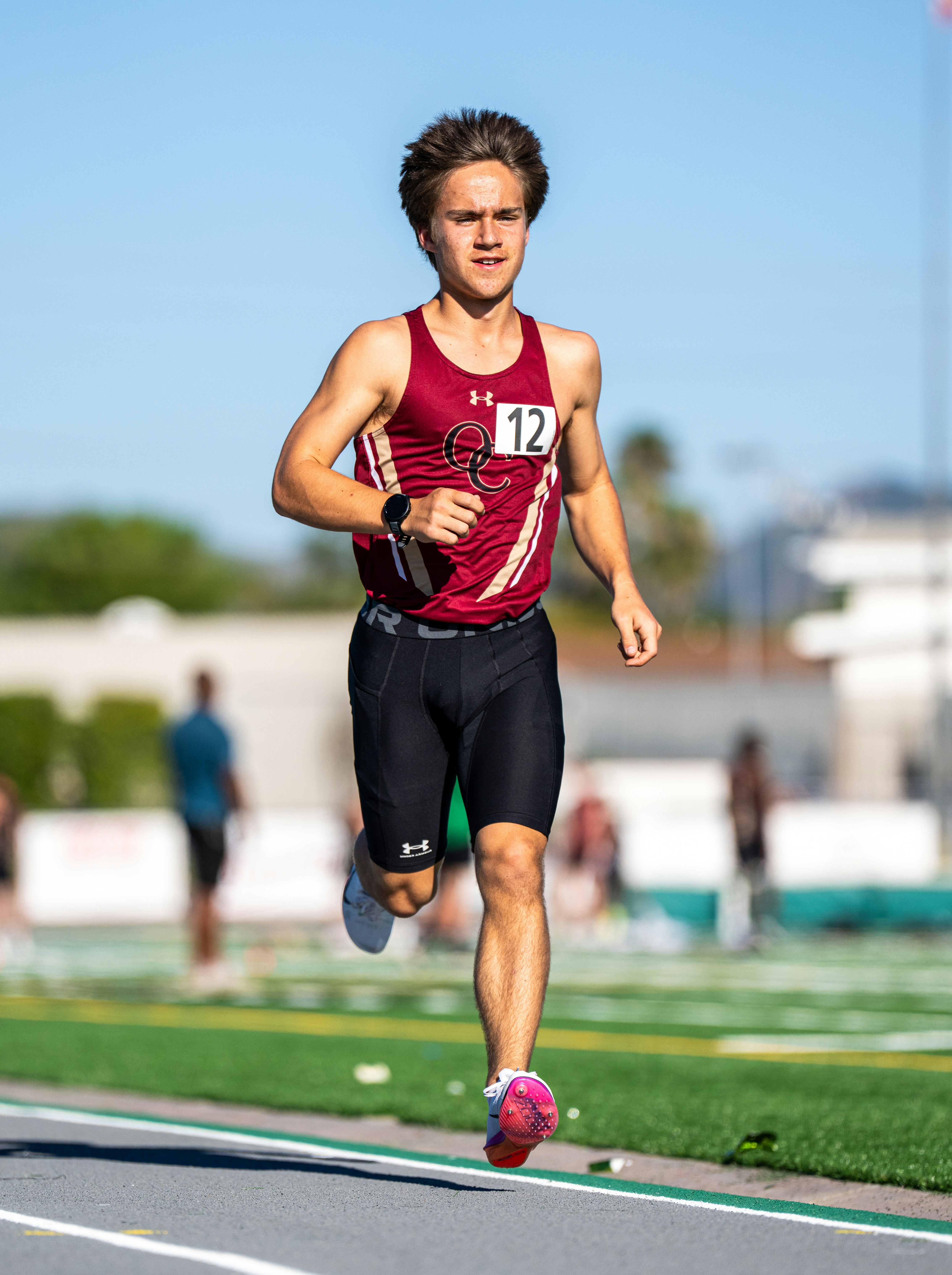 Young male runner competes in a track and field race.