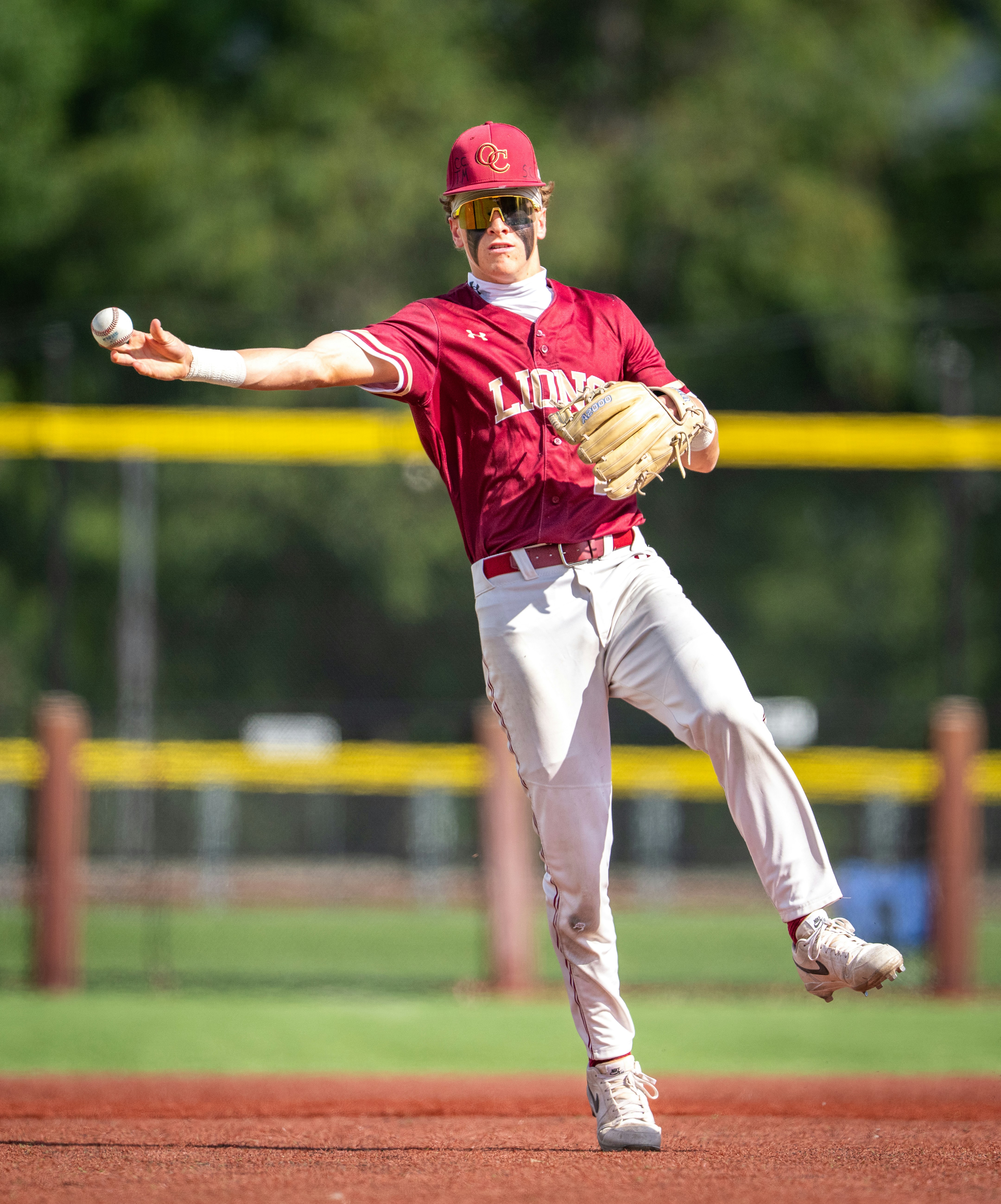 A baseball player throwing a ball on the field.
