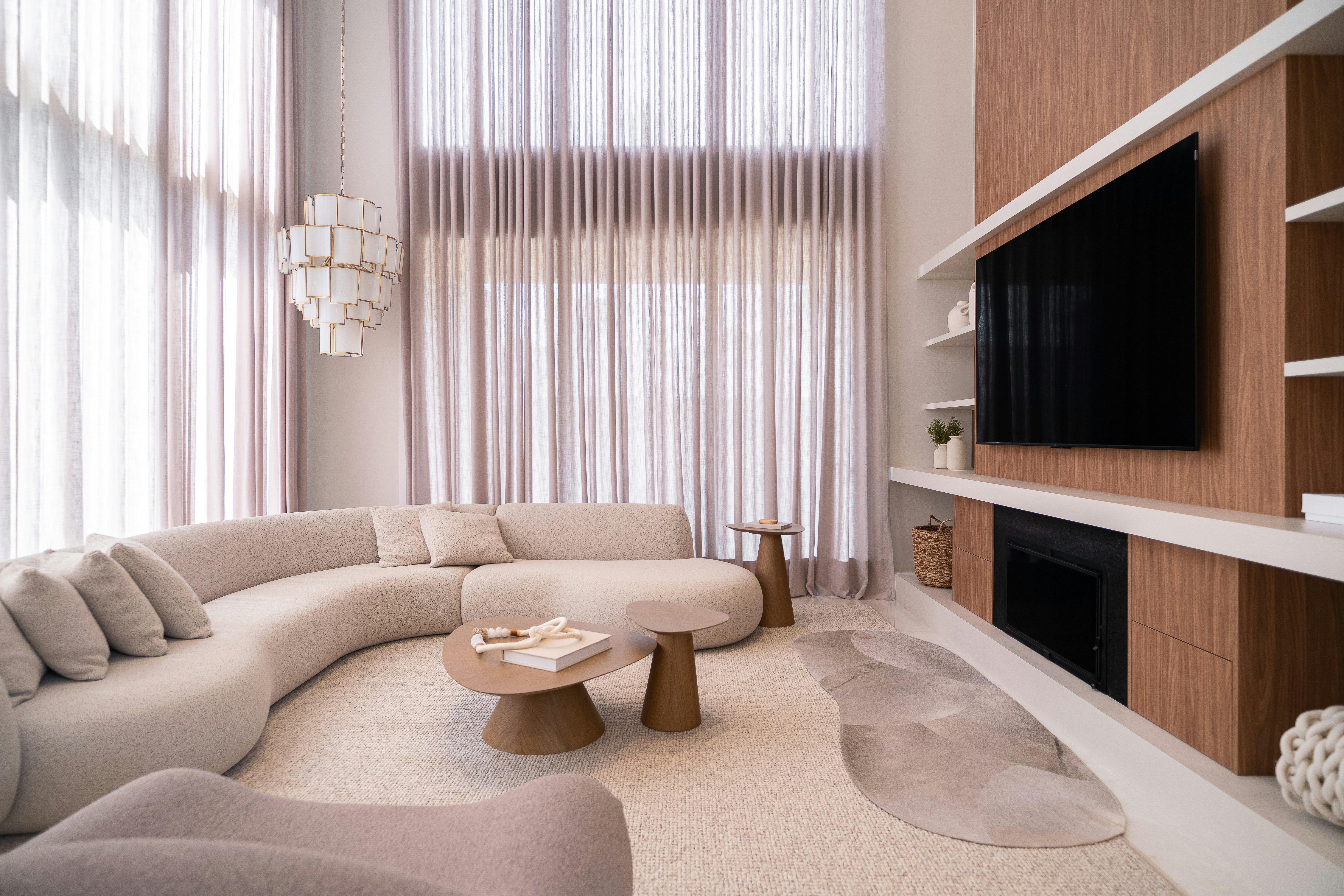 Modern living room with curved sofa and large windows