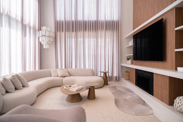 Curved sectional seating in a pale residential lounge