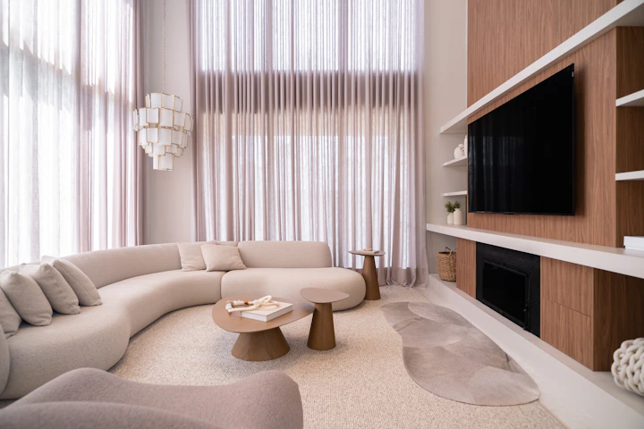 Curved sectional seating in a pale residential lounge
