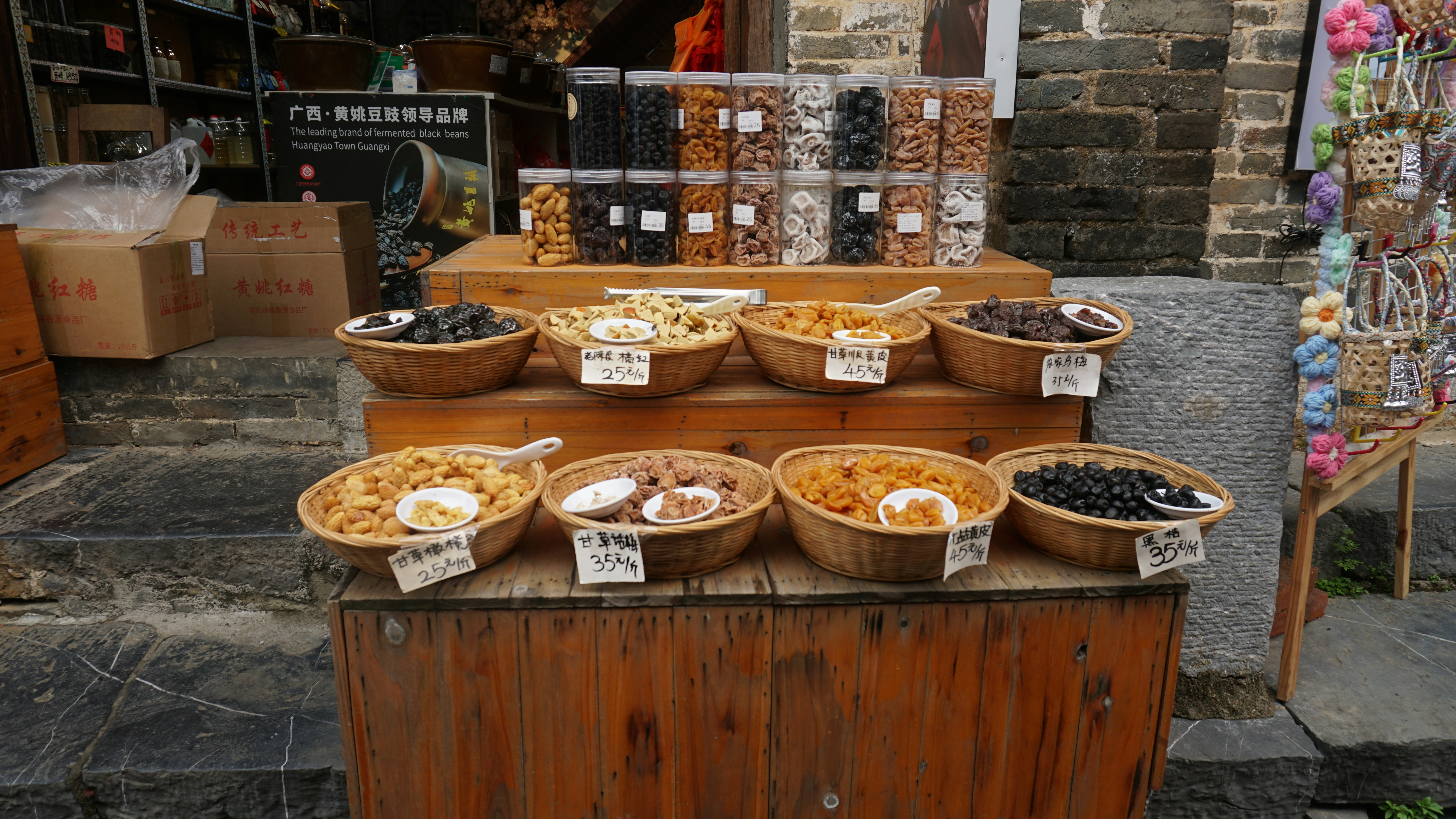 Bowls of dried fruits and nuts displayed outside.