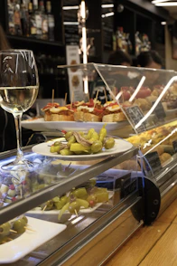Glass of white wine with tapas and appetizers