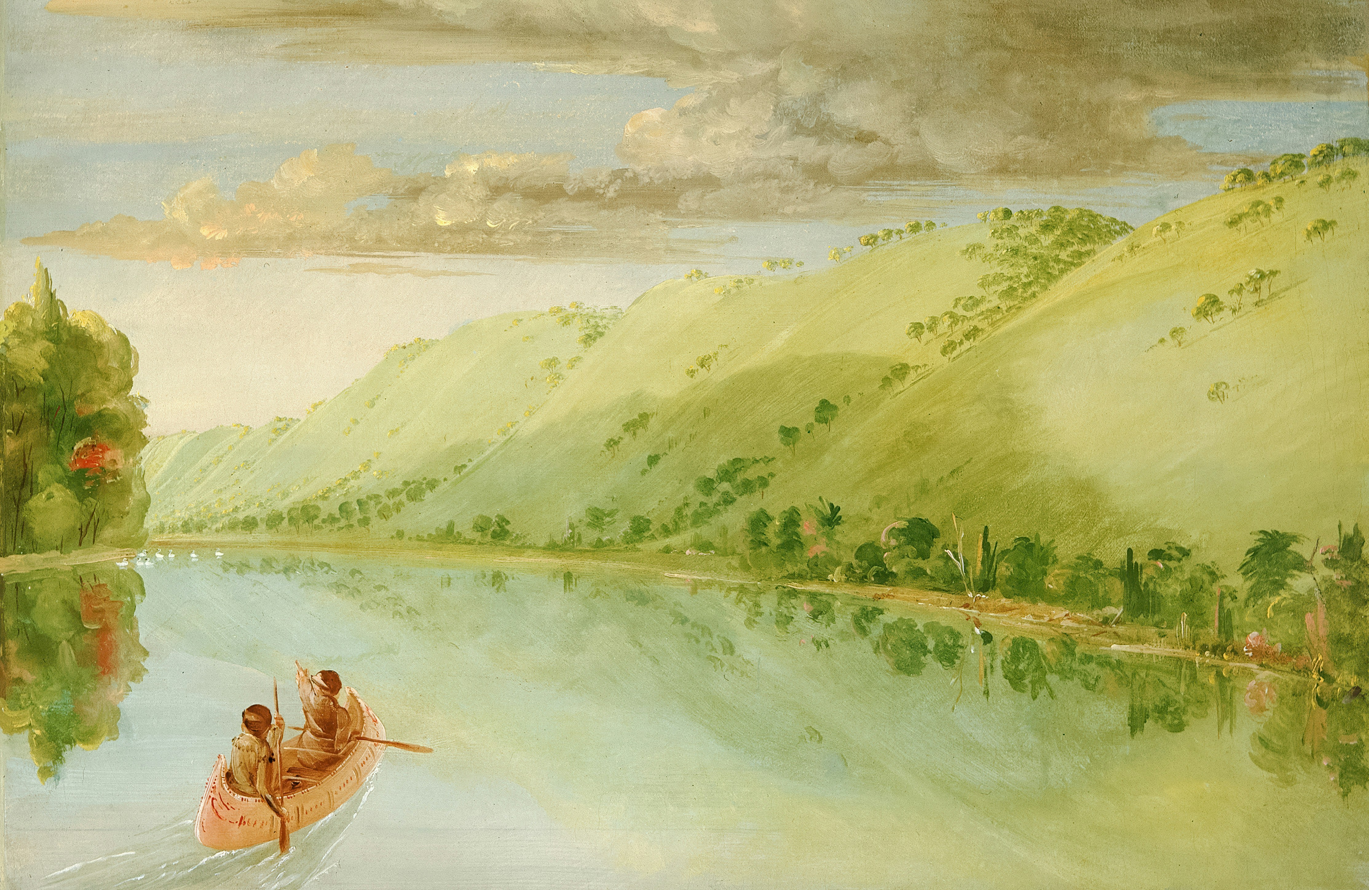 Dos personas en una canoa sobre un río ancho.